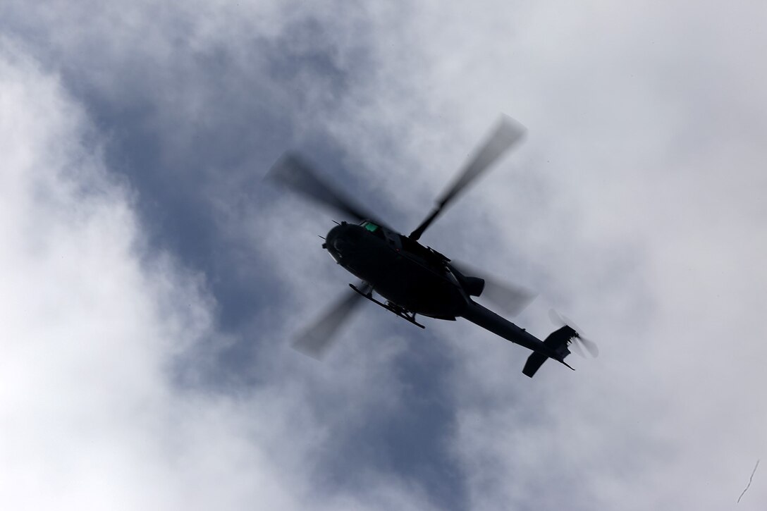 A UH-1Y Super Huey with Marine Medium Tiltrotor Squadron 163 (Reinforced), 11th Marine Expeditionary Unit, hovers above the cargo vessel ATLS as part of a visit board search and seizure (VBSS) mission conducted during Composite Training Unit Exercise (COMPTUEX) off the coast of southern California, May 17, 2014. COMPTUEX is the second at-sea period during the 11th MEU's predeployment cycle, during which the MEU will conduct concurrent mission planning and execution integrated across all elements of the Marine Air Ground Task Force while supporting Amphibious Squadron 5 in their evaluated training. (U.S. Marine Corps photo by Gunnery Sgt. Rome M. Lazarus/Released)