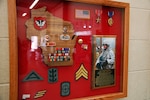 A shadow box dedicated to Sgt. Ryan Adams hangs on a wall in the Army National Guard armory in Rhinelander, Wis., with Adams’ picture and awards. The display serves as a remembrance of his service and sacrifice for fellow Soldiers.