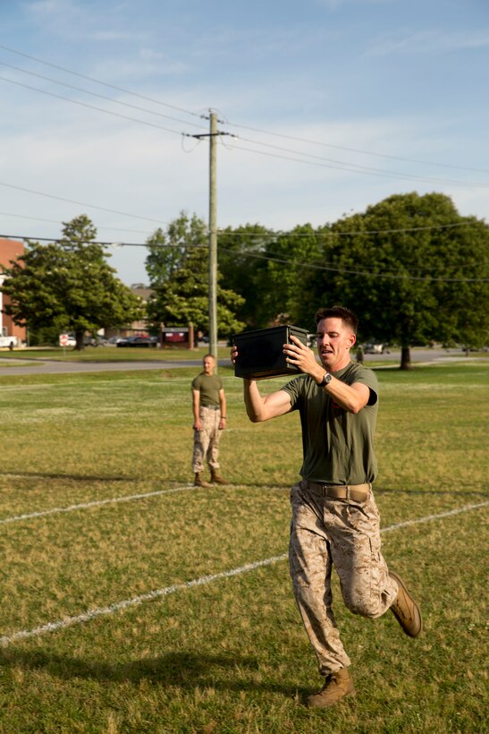 Capt. Anthony Fuhrer, Alpha Company commander with Alpha Company, participates in the ammo can relay race at a field meet held by Headquarters Support Battalion for the units’ monthly Commander’s Cup Challenge, aboard Marine Corps Base Camp Lejeune, May 15. The Commander’s Cup Challenge is a yearlong series of physical competitions where the battalion’s companies build teams to battle it out for fun and a chance to be the top company in the battalion.