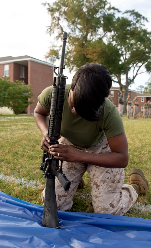 Cpl. Markecia Polk, an administrative specialist with Alpha Company, participates in the rifle assembly and disassembly relay race at a field meet held by Headquarters Support Battalion for the units’ monthly Commander’s Cup Challenge, aboard Marine Corps Base Camp Lejeune, May 15. The Commander’s Cup Challenge is a yearlong series of physical competitions where the battalion’s companies build teams to battle it out for fun and a chance to be the top company in the battalion.