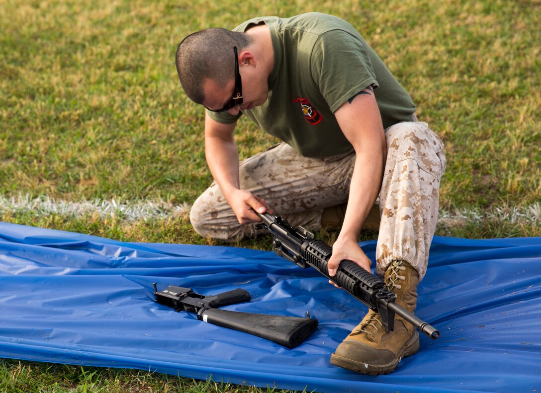 Lance Cpl. Louis Huntoon, a clerk with Alpha Company,, participates in the rifle assembly and disassembly relay race at a field meet held by Headquarters Support Battalion for the units’ monthly Commander’s Cup Challenge, aboard Marine Corps Base Camp Lejeune, May 15. The Commander’s Cup Challenge is a yearlong series of physical competitions where the battalion’s companies build teams to battle it out for fun and a chance to be the top company in the battalion.