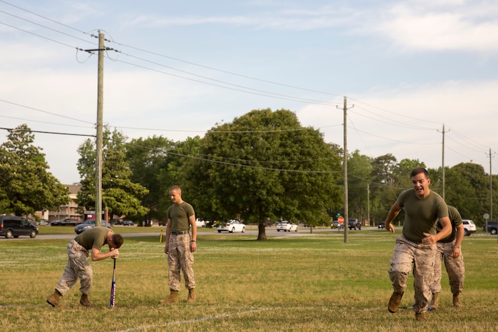 Marines struggle to maintain balance during the dizzy izzy event at a field meet held by Headquarters Support Battalion for the units’ monthly Commander’s Cup Challenge, aboard Marine Corps Base Camp Lejeune, May 15. The Commander’s Cup Challenge is a yearlong series of physical competitions where the battalion’s companies build teams to battle it out for fun and a chance to be the top company in the battalion.