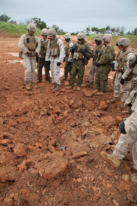 Marines analyze the aftermath of a shape charge during training May 13 in the Central Training Area. The training covered basic demolitions and urban breaching, and taught Marines how to build and place a variety of explosives. The Marines are with Combat Engineer Company, Combat Assault Battalion, 3rd Marine Division, III Marine Expeditionary Force. (U.S. Marine Corps photo by Sgt. Jose O. Nava/Released)  
