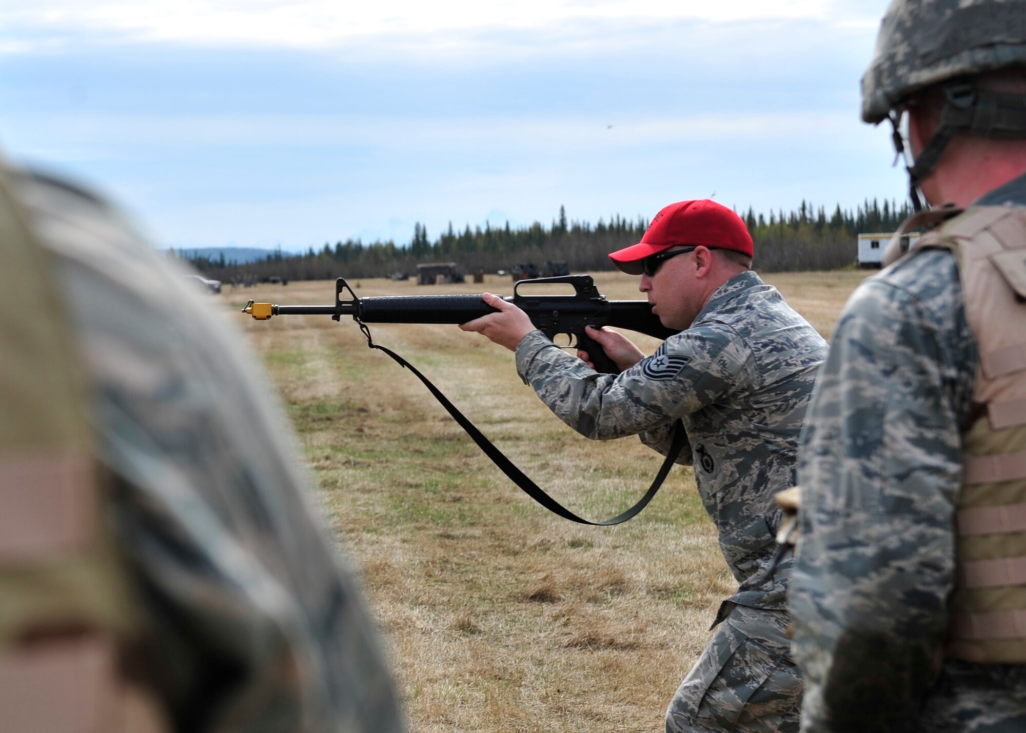 Tech. Sgt. Seth Stinnett, 354th Security Forces Squadron combat arms instructor, demonstrates how to move quickly with an M-16A2 rifle May 15, 2014, Eielson Air Force Base, Alaska. 354th SFS trainers instructed members from the 354th Civil Engineer Squadron on different techniques applicable to deployments. (U.S. Air Force photo by Senior Airman Ashley Nicole Taylor/Released)