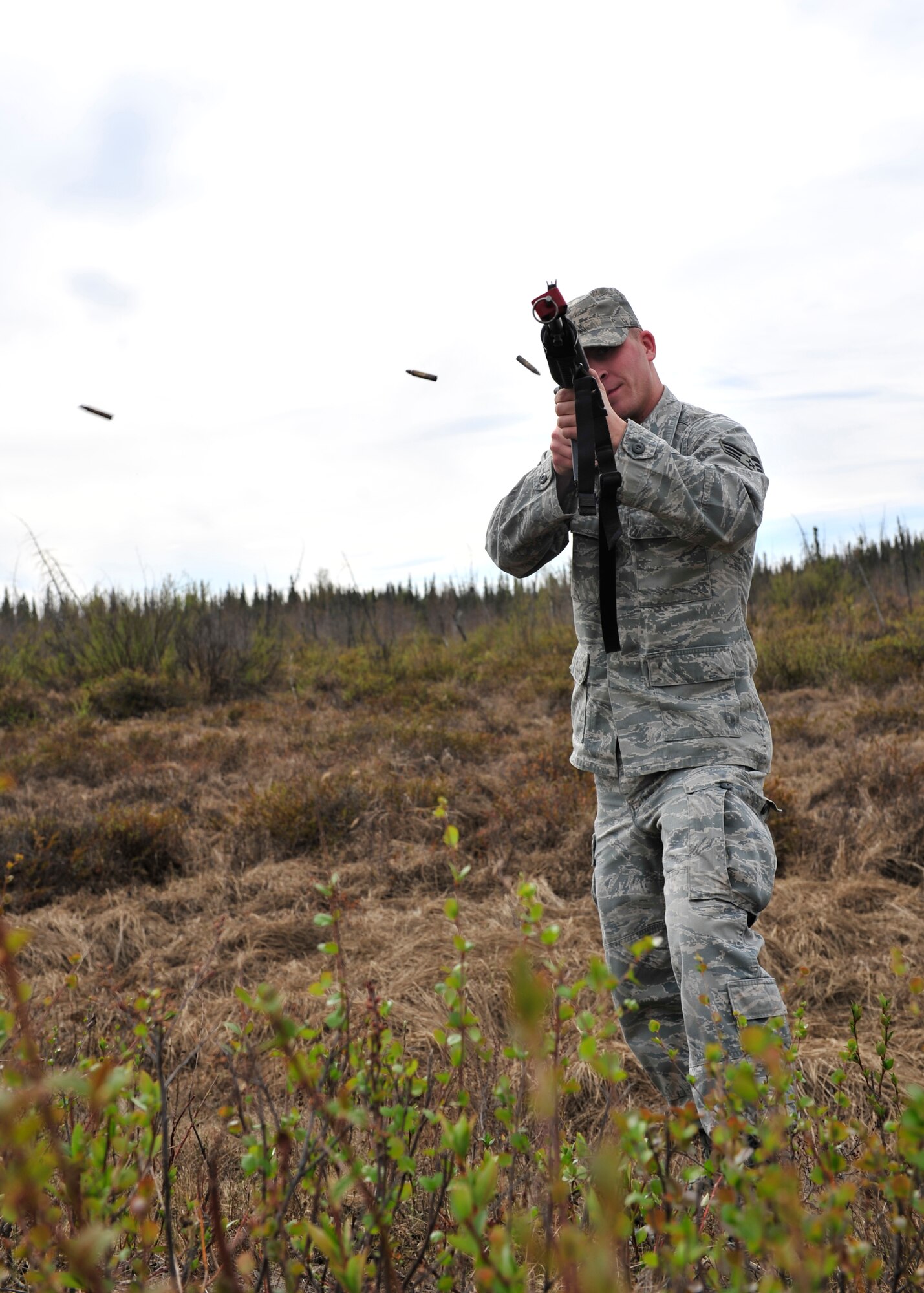Senior Airman Travis Marshall, 354th Civil Engineer Squadron expeditionary engineering programs manager, acts as an opposing force during individual movement training May 15, 2014, Eielson Air Force Base, Alaska. 354th CES members shot M-16A2 rifles with a blank firing adapter to train for potential combat situations. (U.S. Air Force photo by Senior Airman Ashley Nicole Taylor/Released)