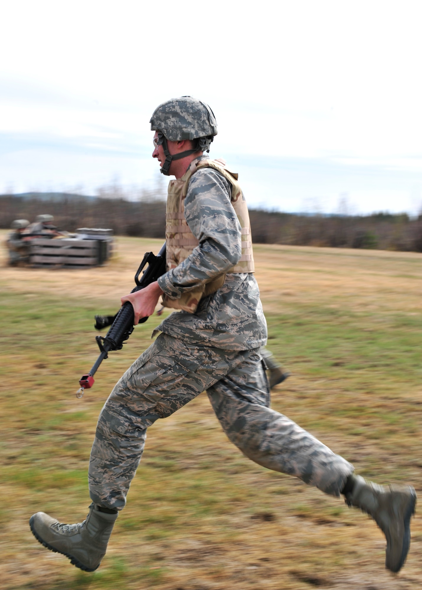 2nd Lt. Samuel Joslin, 354th Civil Engineer Squadron project programmer, runs for cover during individual movement training May 15, 2014, Eielson Air Force Base, Alaska. Over 40 members of the 354th CES were taught different movement techniques by 354th Security Forces Squadron trainers during a Prime BEEF day. (U.S. Air Force photo by Senior Airman Ashley Nicole Taylor/Released)