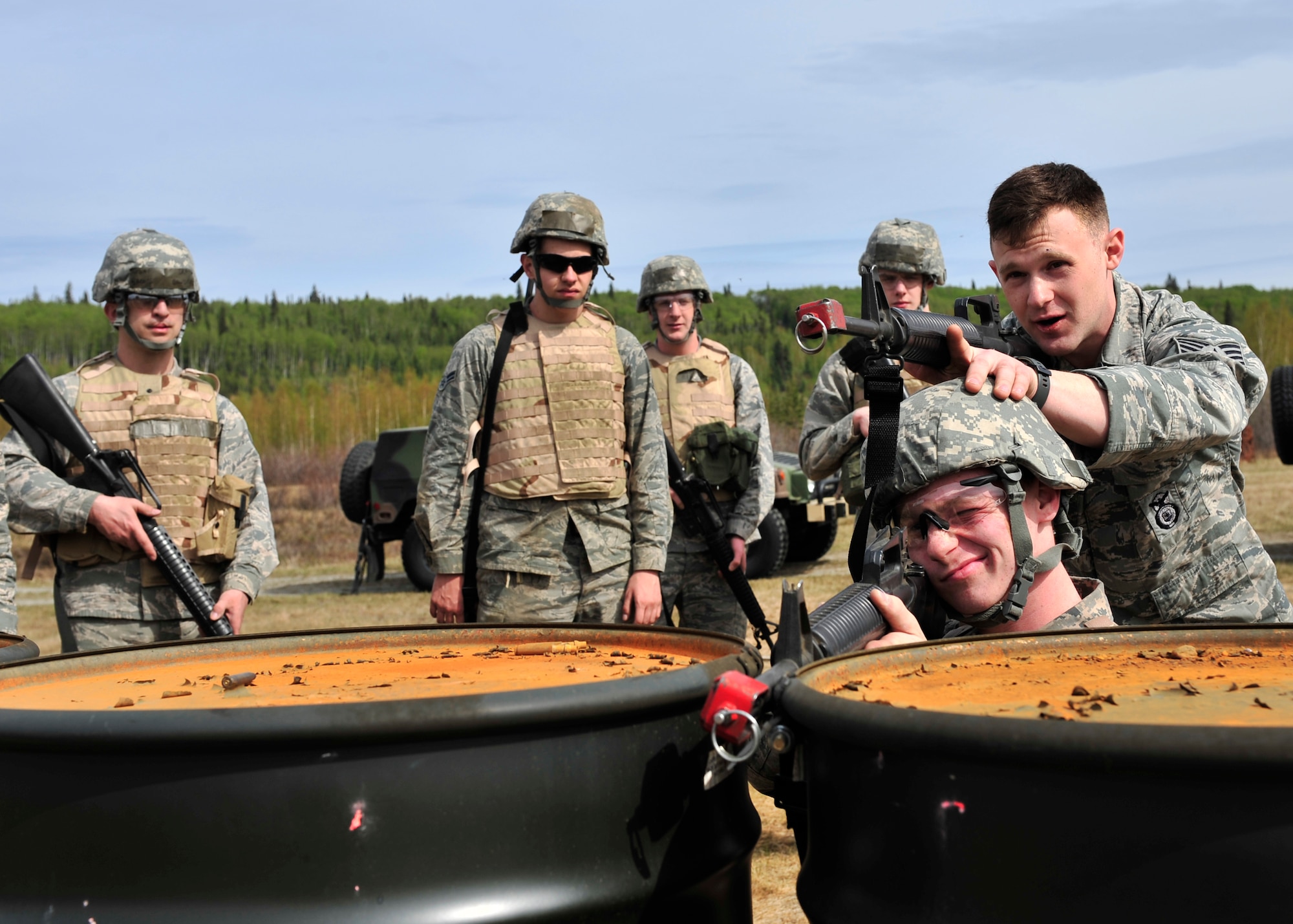 Staff Sgt. Sean Reval, 354th Security Forces Squadron training instructor, demonstrates concealment and cover during individual movement training May 15, 2014, Eielson Air Force Base, Alaska. Reval taught members of the 354th Civil Engineer Squadron the importance of taking cover and the proper ways to execute verbal commands. (U.S. Air Force photo by Senior Airman Ashley Nicole Taylor/Released)