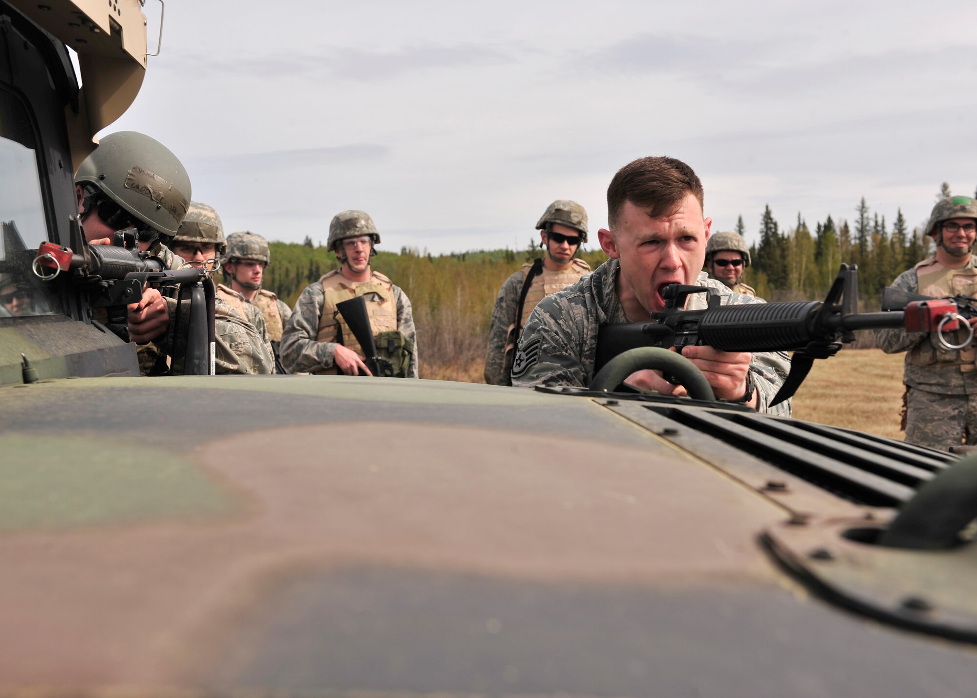Staff Sgt. Sean Reval, 354th Security Forces Squadron training instructor, teaches members of the 354th Civil Engineer Squadron how to yell movement commands May 15, 2014, Eielson Air Force Base, Alaska. Reval taught 354th CES members to effectively communicate in a combat environment. (U.S. Air Force photo by Senior Airman Ashley Nicole Taylor/Released)