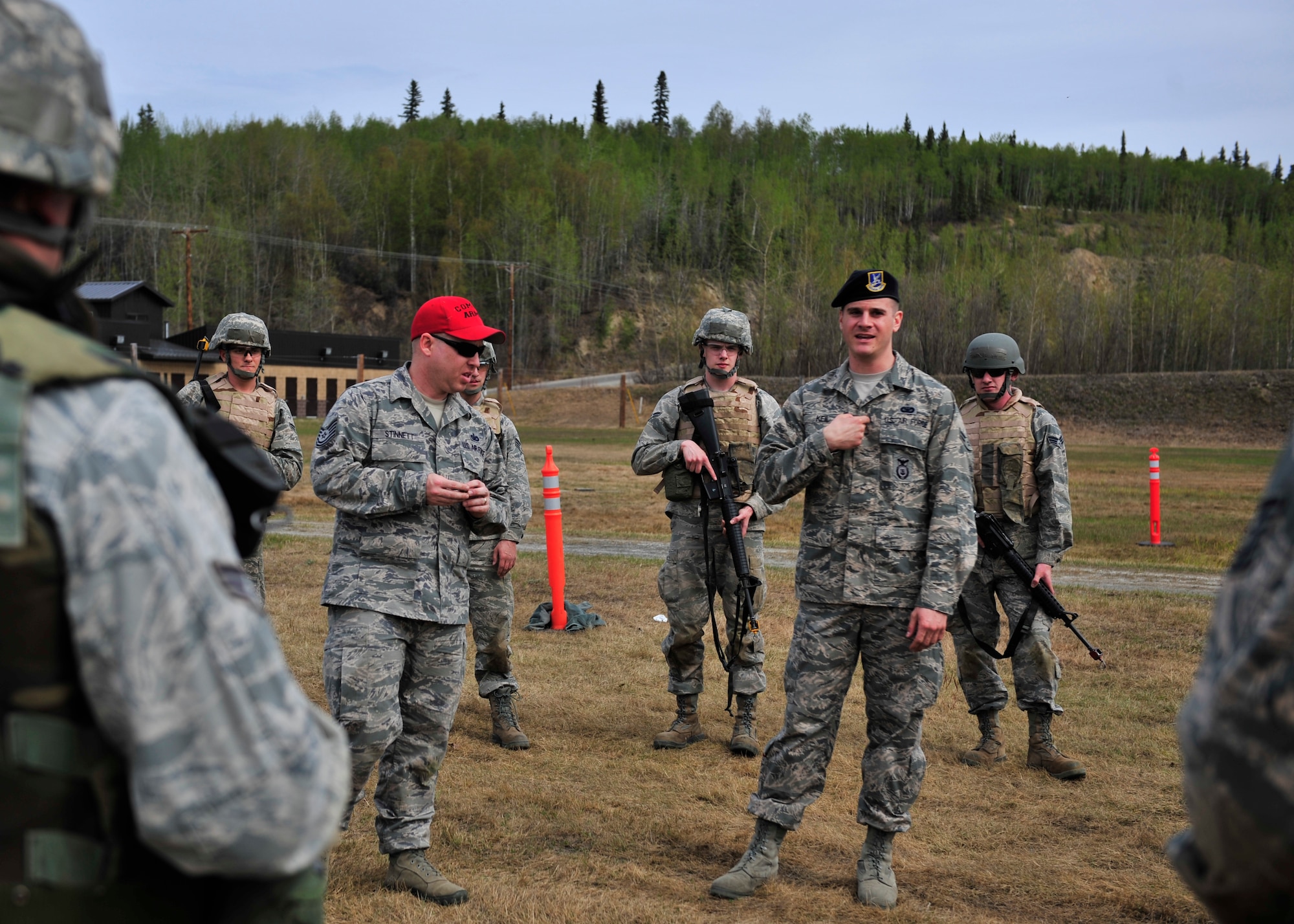 Airman 1st Class Christopher Keil, 354th Security Forces Squadron trainer, demonstrates where to shoot an opposing force May 15, 2014, Eielson Air Force Base, Alaska. Keil and other defenders taught members of the 354th Civil Engineer Squadron different combat skills that can carry over to deployments. (U.S. Air Force photo by Senior Airman Ashley Nicole Taylor/Released)