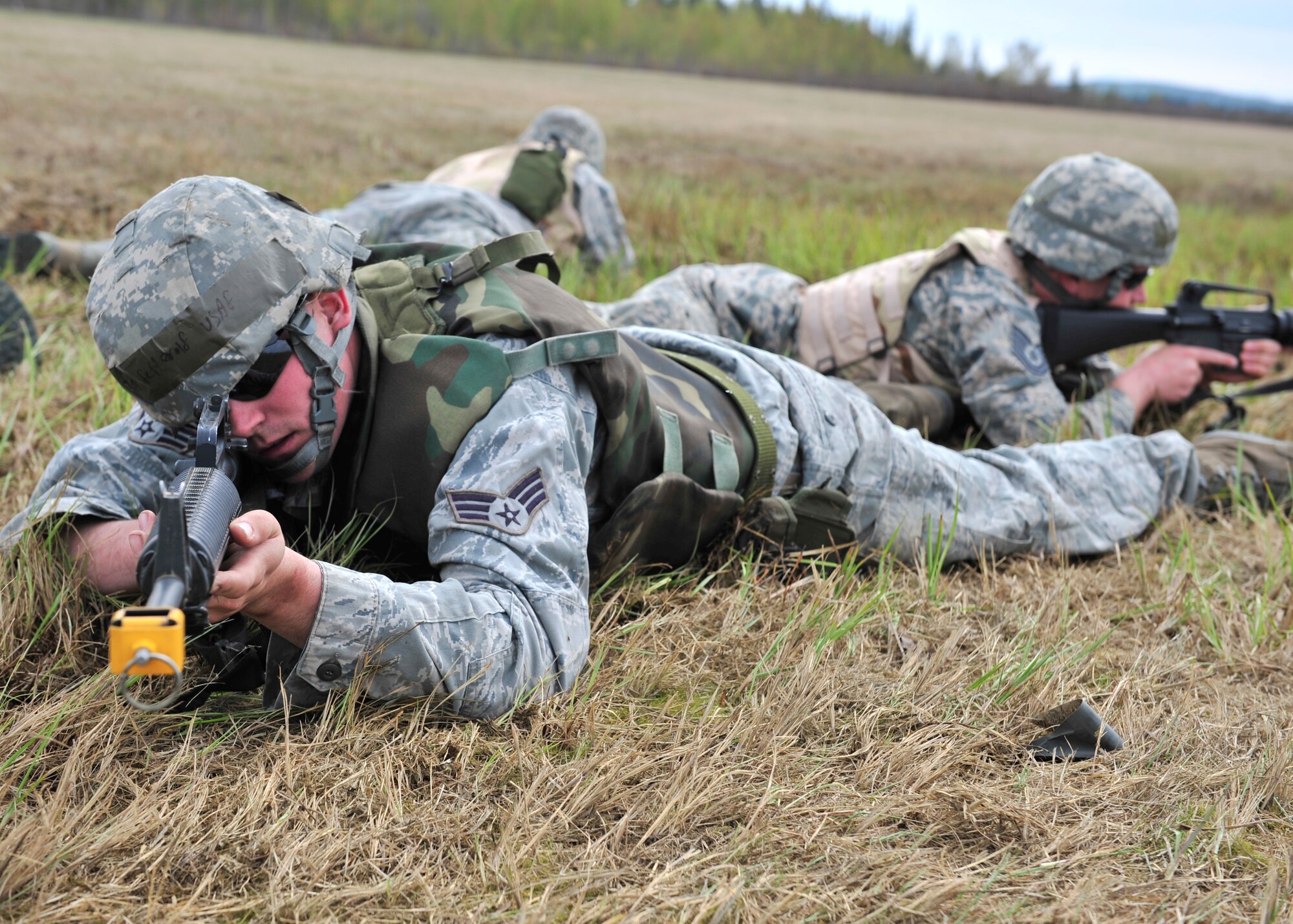 Senior Airman Charles Fetterolf, 354th Civil Engineer Squadron power plant coal crew member, covers other 354th CES members during individual movement training May 15, 2014, Eielson Air Force Base, Alaska. 354th CES members were taught different camouflaging techniques to keep themselves hidden from an opposing force. (U.S. Air Force photo by Senior Airman Ashley Nicole Taylor/Released)   