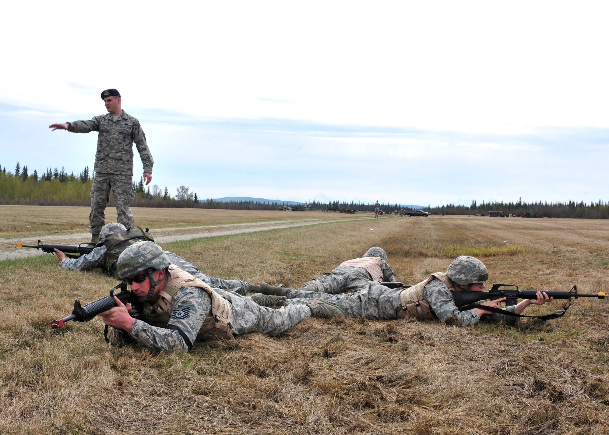Airman 1st Class Christopher Keil, 354th Security Forces Squadron trainer, directs members of the 354th Civil Engineer Squadron on how to safely cover each other during movement training May 15, 2014, Eielson Air Force Base, Alaska. This was the first time 354th SFS taught 354th CES members techniques that can be used in deployed locations. (U.S. Air Force photo by Senior Airman Ashley Nicole Taylor/Released)