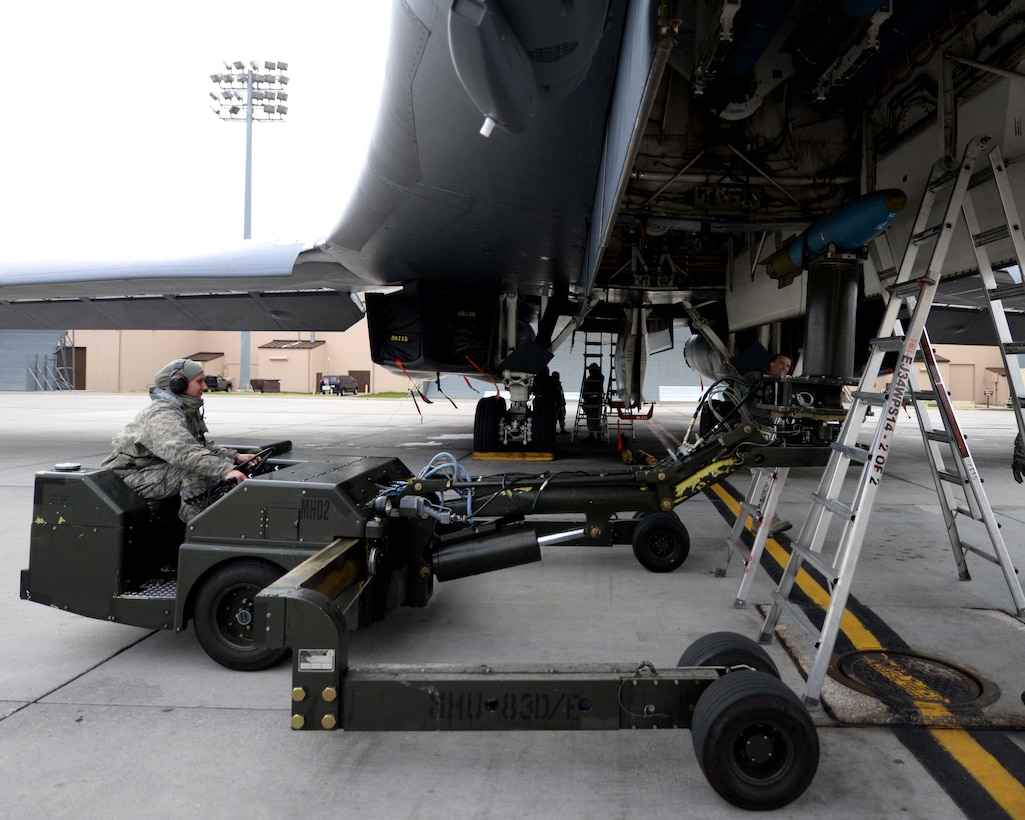Airman Sidney Hering, 28th Aircraft Maintenance Squadron weapons load crewmember, uses a ram jammer to load an inert 500-pound training munition in preparation for a Global Power Mission  from Ellsworth Air Force Base, S.D., May 12, 2014. During the mission, B-1 aircrews flew 13,200 miles round trip and employed munitions accurately within a 5 meter target area on a training range near Guam. (U.S. Air Force photo by Airman 1st Class Rebecca Imwalle/Released) 