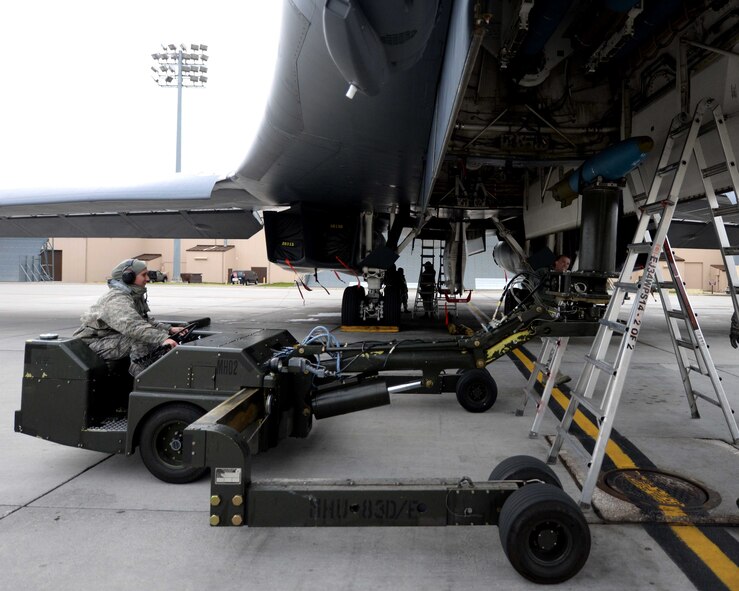 Airman Sidney Hering, 28th Aircraft Maintenance Squadron weapons load crewmember, uses a ram jammer to load an inert 500-pound training munition in preparation for a Global Power Mission  from Ellsworth Air Force Base, S.D., May 12, 2014. During the mission, B-1 aircrews flew 13,200 miles round trip and employed munitions accurately within a 5 meter target area on a training range near Guam. (U.S. Air Force photo by Airman 1st Class Rebecca Imwalle/Released) 