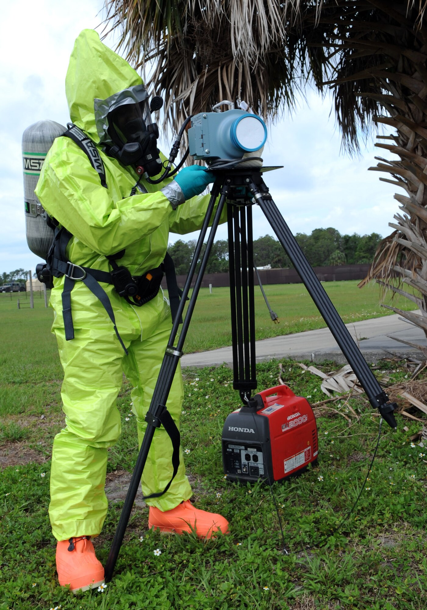 Staff Sgt. Grady Holmes, 6th Aerospace Medicine Squadron bioenvironmental engineer flight technician, sets up a high volume air sampler during integrated base emergency response training at MacDill Air Force Base, Fla., May 15, 2014. The high volume air sampler is used to collect alpha and beta radiation particles in the air. (U.S. Air Force photo by Airman 1st Class Tori Schultz/Released)