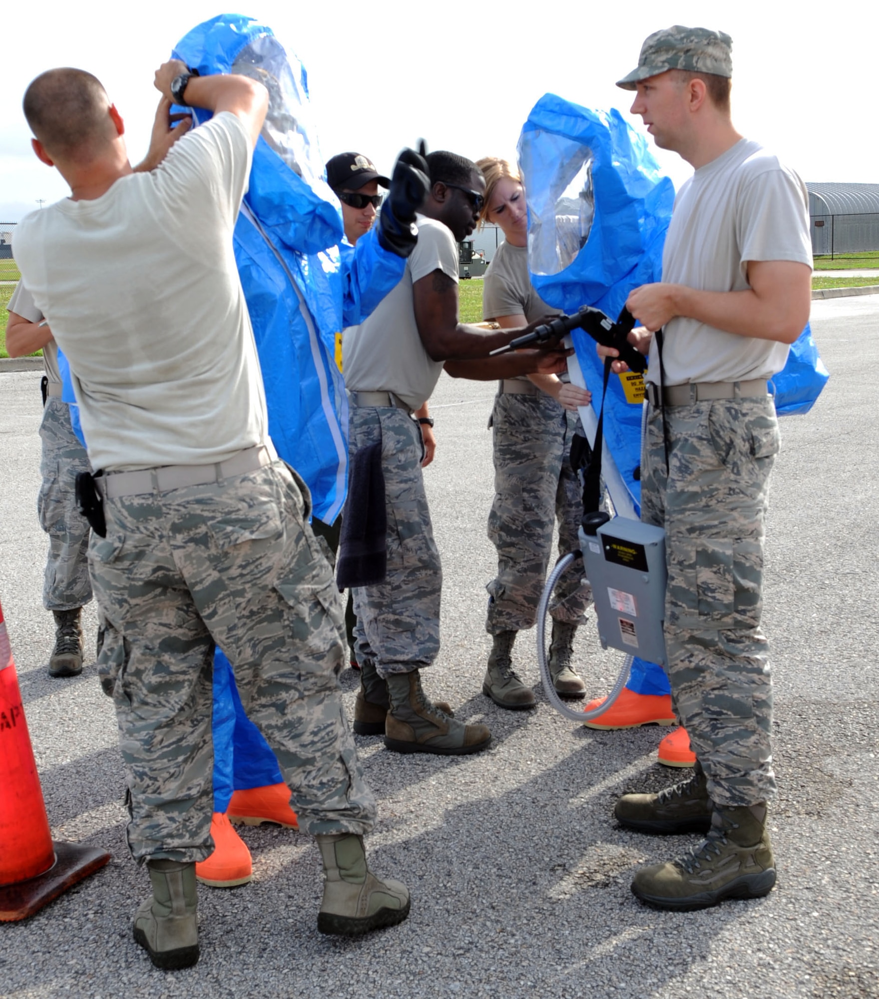 Tech. Sgt. Wayne Johansen, 6th Aerospace Medicine Squadron NCO in-charge contingency health element, and Staff Sgt. Jason Espurvoa, 6th AMDS bioenvironmental engineer flight technician, prepare to go into a simulated radiation scenario at MacDill Air Force Base, Fla., May 15, 2014. Care must be taken to ensure all seals are secured and closed to keep technicians safe inside their suits. (U.S. Air Force photo by Airman 1st Class Tori Schultz/Released)