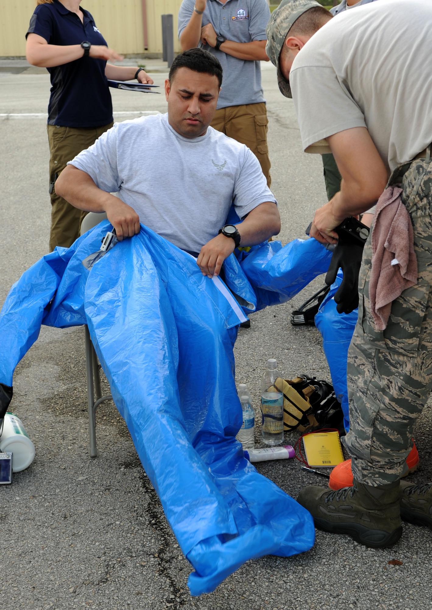 Staff Sgt. Jason Espurvoa, 6th Aerospace Medicine Squadron bioenvironmental engineer flight technician, gets suited up during an integrated base emergency response training at MacDill Air Force Base, Fla., May 15, 2014. The suit helps protect the body from hazardous environments. (U.S. Air Force photo by Airman 1st Class Tori Schultz/Released)