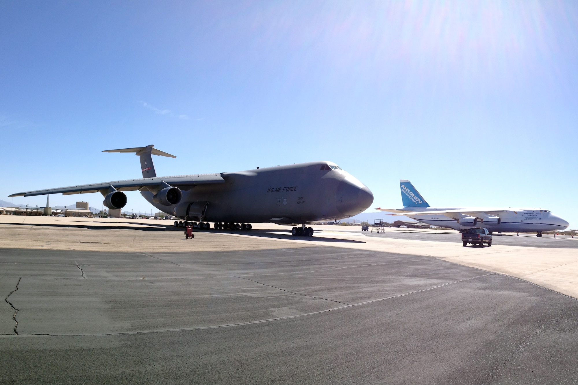 An unloaded Antonov An-124 stages next to a C-5 Galaxy on standby to be loaded with personnel and equipment to be flown to exercise Red Flag Alaska at Davis-Monthan Air Force Base, Ariz., May 6, 2014. The Ukrainian built Antonov An-124 was on station in support of ANGEL THUNDER, the world?s largest joint multinational interagency Combat, Search and Rescue exercise. (U.S. Air Force photo by Maj. Marc Hernandez/Released)