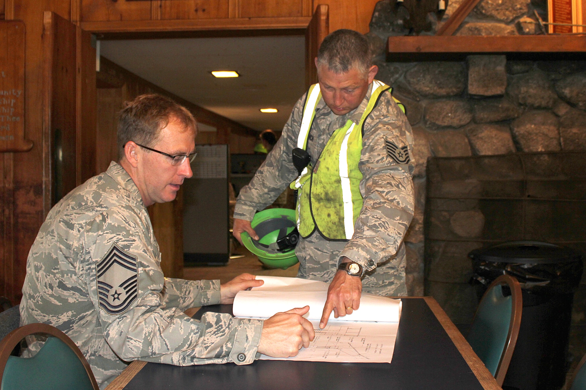 140521-Z-VA676-020 -- Chief Master Sgt. Jeff Talaga and Technical Sgt. Dan Gerlach review a set of building plans prior to beginning the day?s work at Camp Hinds Boy Scout Camp, Raymond, Maine, May 21, 2014. Talaga and Gerlach are members of the 127th Civil Engineer Squadron, based at Selfridge Air National Guard Base, Mich. The Airmen, along with Marine Corps Reservists and Army Reservists, are working on various construction projects at the camp during an Innovative Readiness Training mission, which allows military personnel to get training in various tasks and a community organization, in this case the Boy Scouts, to benefit from the work. (U.S. Air National Guard photo by Technical Sgt. Dan Heaton)