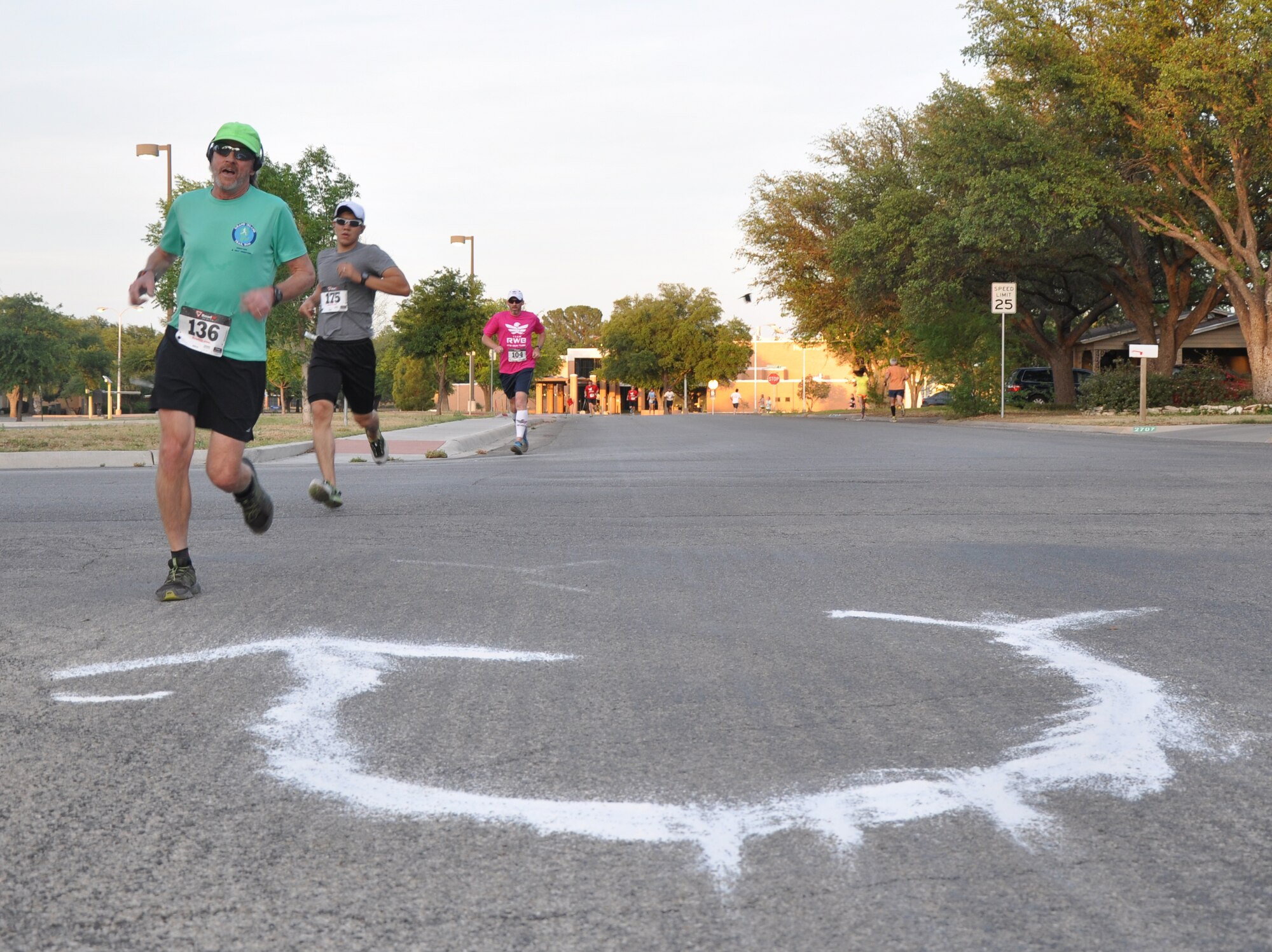 SAN ANGELO, Texas – Kent Fish, Jeremy Ochoa and Tim Masshardt, Relay for Life participants, reach the halfway point during one of the hourly events held for the Relay for Life at the Angelo State University here May 16. The 5K along with goldfish races and food stalls were part of a final push to help boost donations for the relay. (U.S. Air Force photo/ Senior Airman Joshua Edwards)