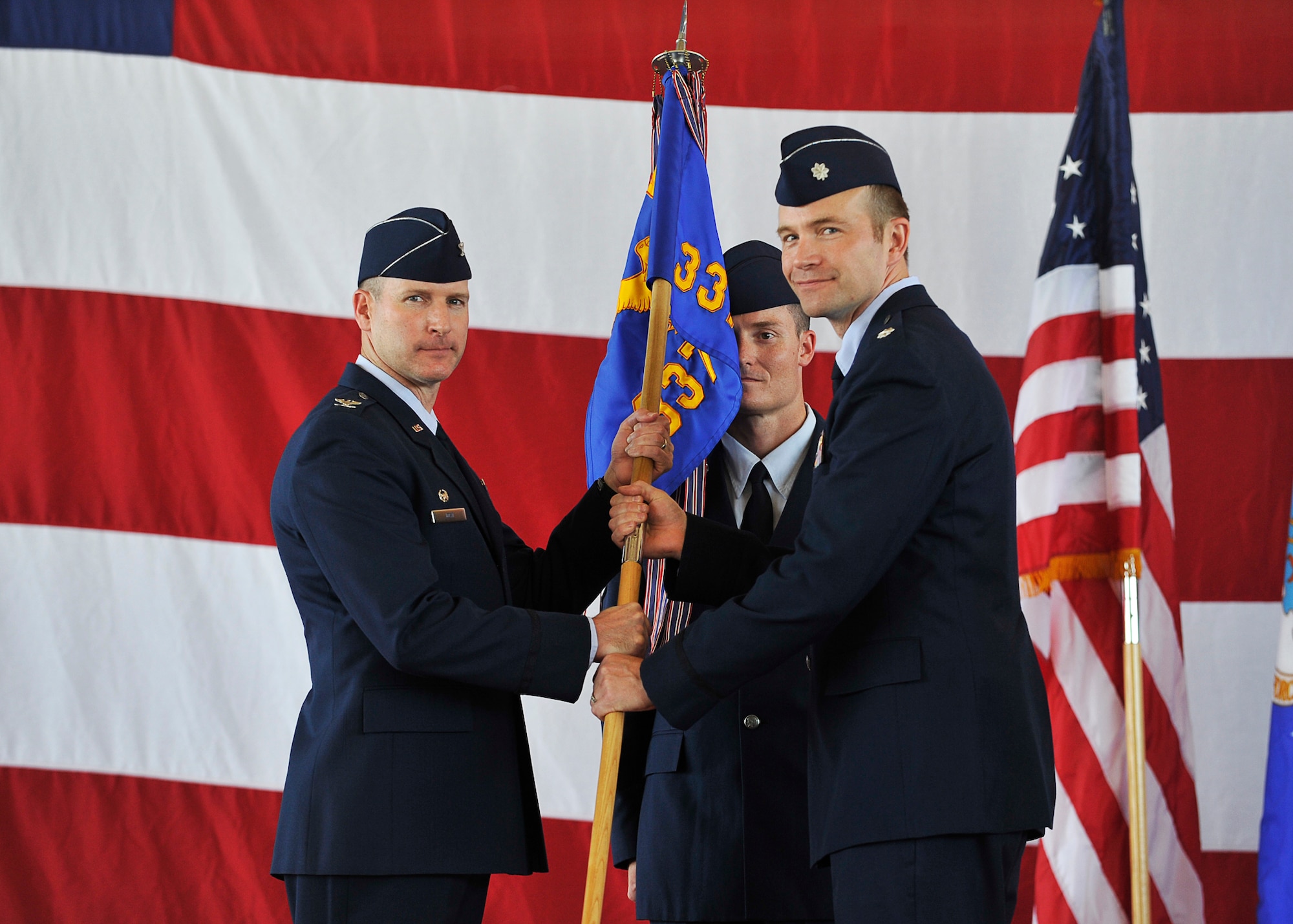 Col. Stephen F. Jost, 33rd Operations Group commander, Eglin AFB, Fla., passes the 337th ACS guidon to Lt. Col. Michael Hagan during the 337th ACS change of command ceremony May 21 at the squadron here. (U.S. Air Force photo by Tech. Sgt. Javier Cruz)