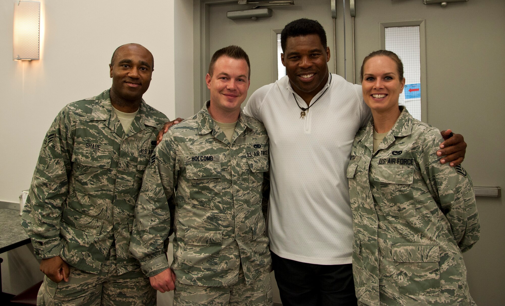 Airmen from the 442nd Fighter Wing pose for a photo with Herschel Walker May 21, 2014, at Whiteman Air Force Base, Missouri. In addition to being an NFL star and a bob sled team Olympian, Walker has also been a professional MMA competitor. (U.S. Air Force photo by Senior Airman Daniel Phelps/Released)