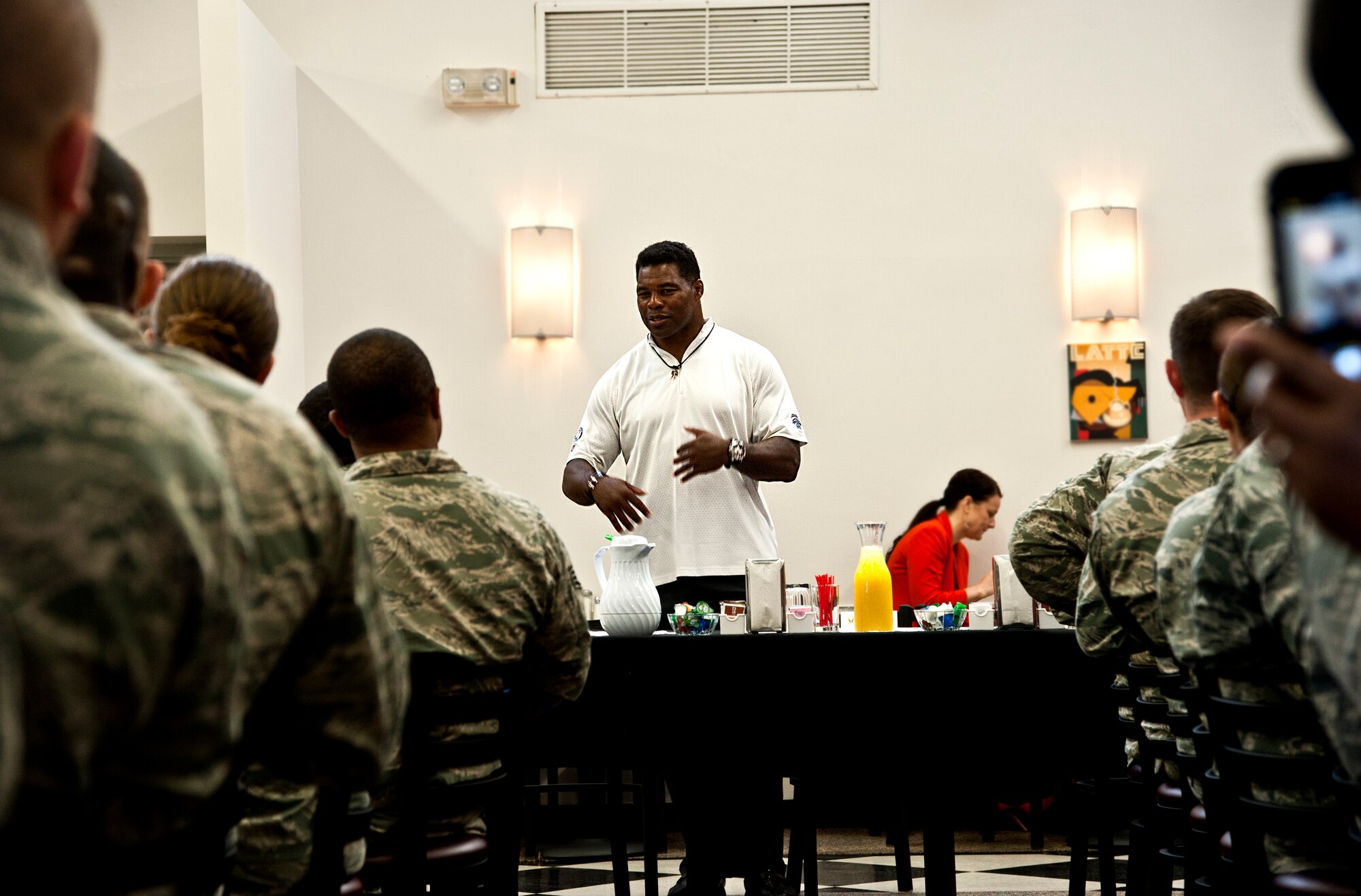 Herschel Walker shares his story with Airmen from Team Whiteman during a breakfast May 21, 2014, at Whiteman Air Force Base, Missouri. Walker is a former NFL star and “Celebrity Apprentice” contestant. (U.S. Air Force photo by Senior Airman Daniel Phelps/Released)