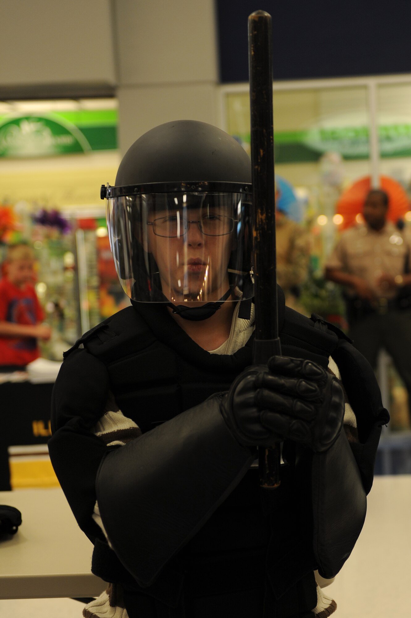 Alex Bendele, 14, tries on equipment used by police on- and off-base at Scott Air Force Base, Ill. on May 15, 2014. The 375th Security Forces Squadron teamed up with police from the surrounding community to educate the public about the purpose of the police and the equipment they employ. (U.S. Air Force photo by Senior Airman Sarah Hall-Kirchner/Released)