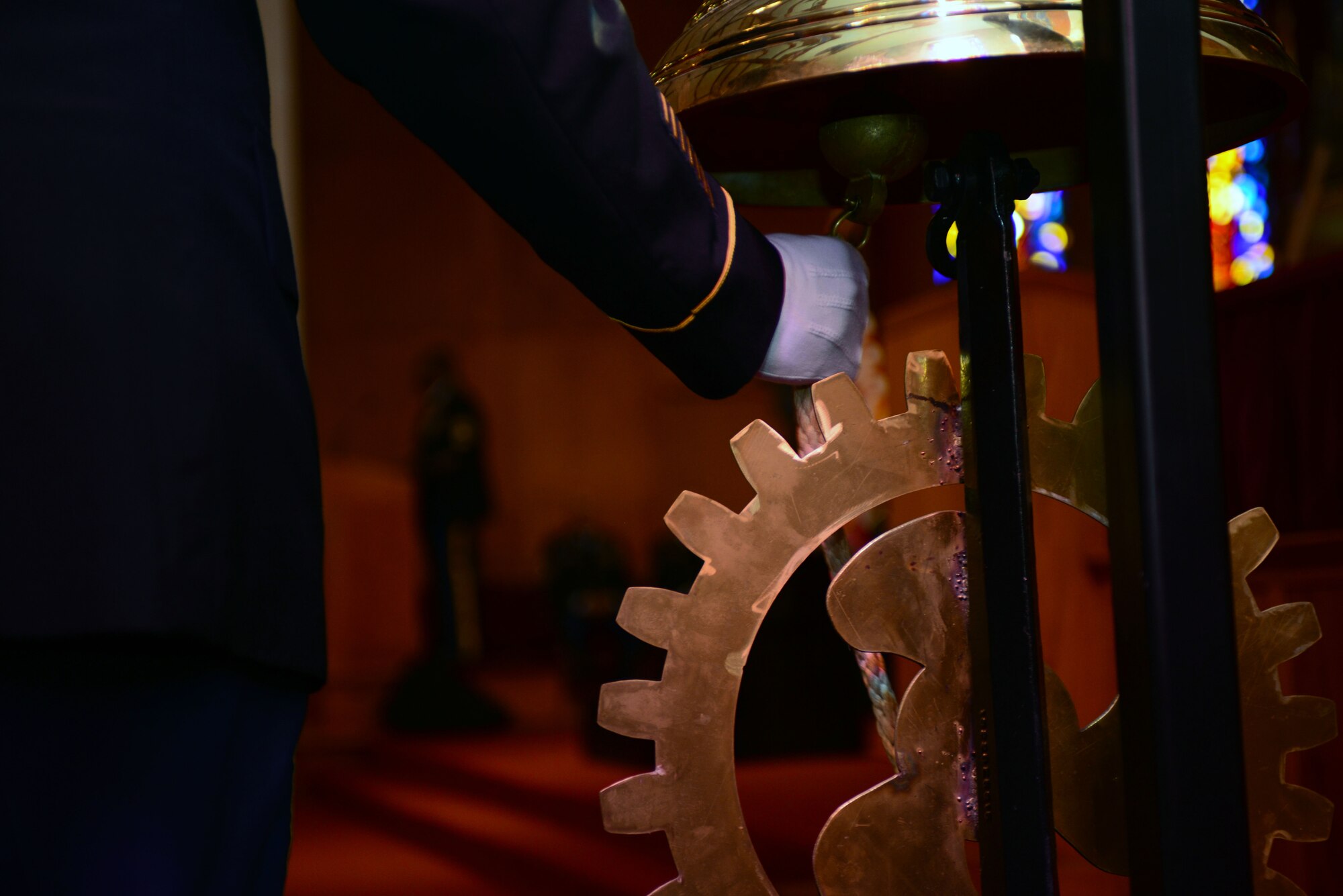 Sergeant 1st Class Thaddeus Merritt, Fort Lee, Va., Noncommissioned Officer Academy senior advance leader course small group leader, rings the ceremonial bell as names of fallen Soldiers are read during the Transportation Corps Memorial Wall Rededication Ceremony at Fort Eustis, Va., May 21, 2014.  The Memorial Wall is located in the Transportation Corps  Regimental  Chapel at Fort Eustis, and is inscribed with 1,972 names of Army transporters who gave their lives in the defense of freedom in conflicts ranging from the Vietnam War to Operations Iraqi and Enduring Freedom. (U.S. Air Force photo by Staff Sgt. Katie Gar Ward/Released) 
