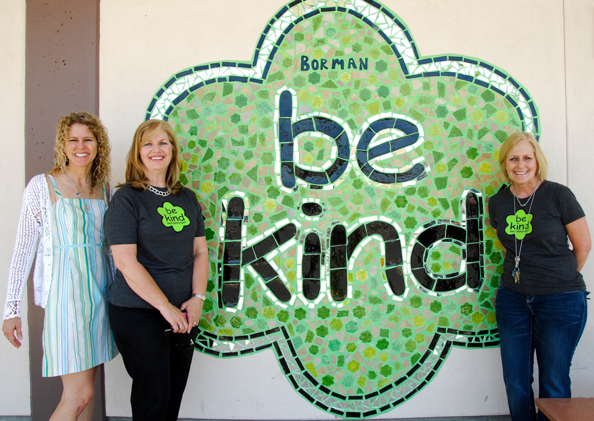 Jeannette Mare, Ben’s Bells Project founder, Martha Damek, Frank Borman Elementary student counselor and Kathy Sisler, Frank Borman Elementary principal, stand in front of the “be kind” mural inside the school at Davis-Monthan Air Force Base, Ariz., May 21, 2014. The mural was created by the Ben’s Bells Project for the school’s participation in the Ben's Bells Kindness Education Programs. (U.S. Air Force photo by Staff Sgt. Angela Ruiz/Released)