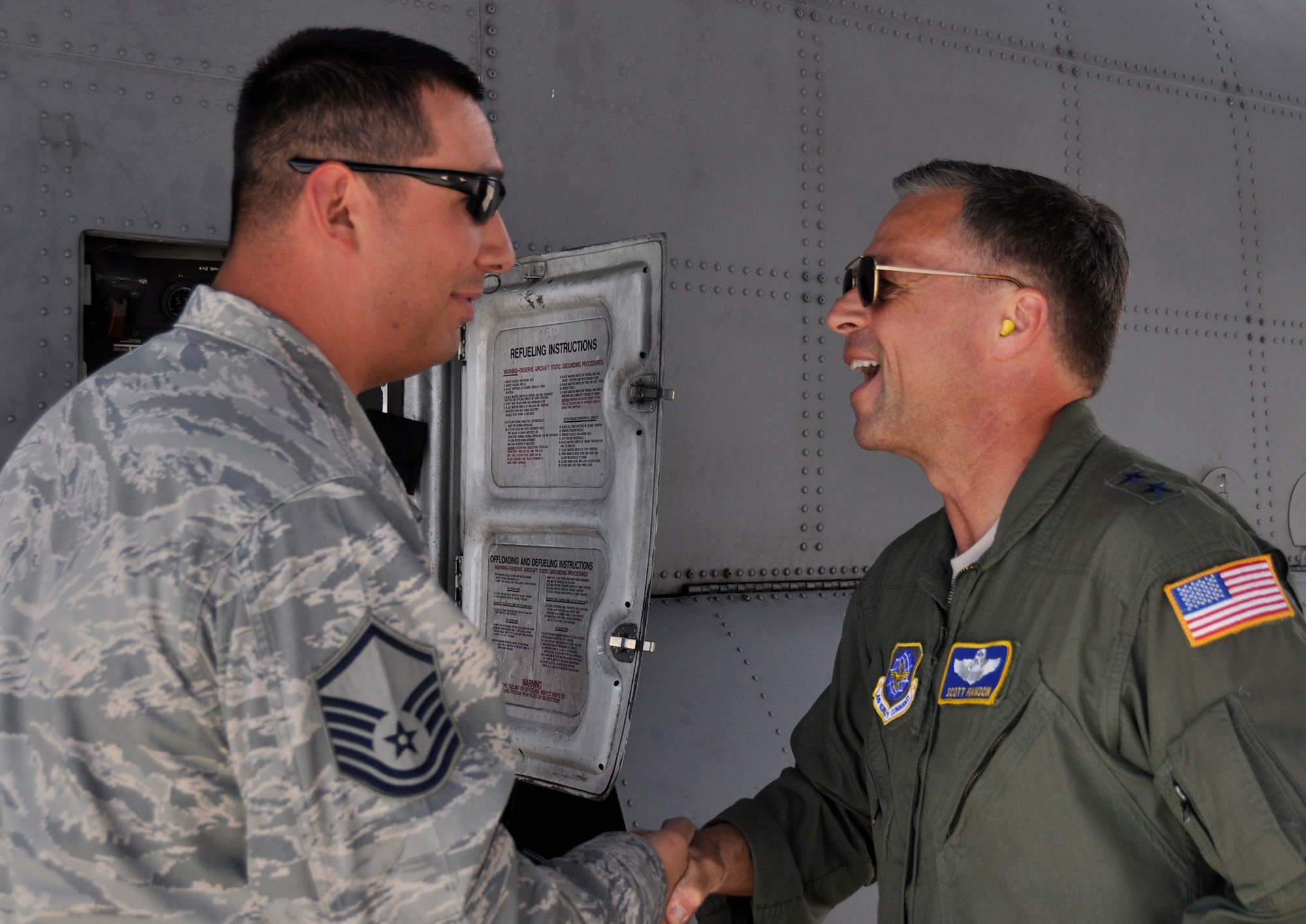 Master Sgt. Rocky Ramirez is “coined” by Maj. Gen. Scott Hanson after the general took a ride on a Modular Airborne Fire Fighting System training flight. “He just wanted to say thank you for the job that we do and wanted to say thanks for keeping the plane in such good shape and looking so nice.  He said it was a great mission that we have. He was very impressed,” said Ramirez, a dedicated crew chief with the 302nd Aircraft Maintenance Squadron. Hanson, Air Mobility Command Director of Operations, visited the Air Force Reserve Command’s 302nd Airlift Wing May 17 to get a first-hand look at MAFFS certification. (U.S. Air Force photo/Master Sgt. Daniel Butterfield)
