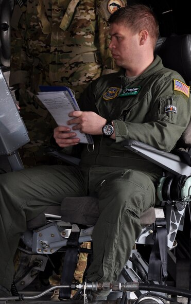 Tech. Sgt. Matt Lafever, C-130H loadmaster, goes through a checklist before the inaugural sortie of 2014 Modular Airborne Fire Fighting System training May 17 at Peterson Air Force Base. Lafever is a member of the 52nd Airlift Squadron, the active associate squadron of the Air Force Reserve Command’s 302nd Airlift Wing. (U.S. Air Force photo/Master Sgt. Daniel Butterfield) 