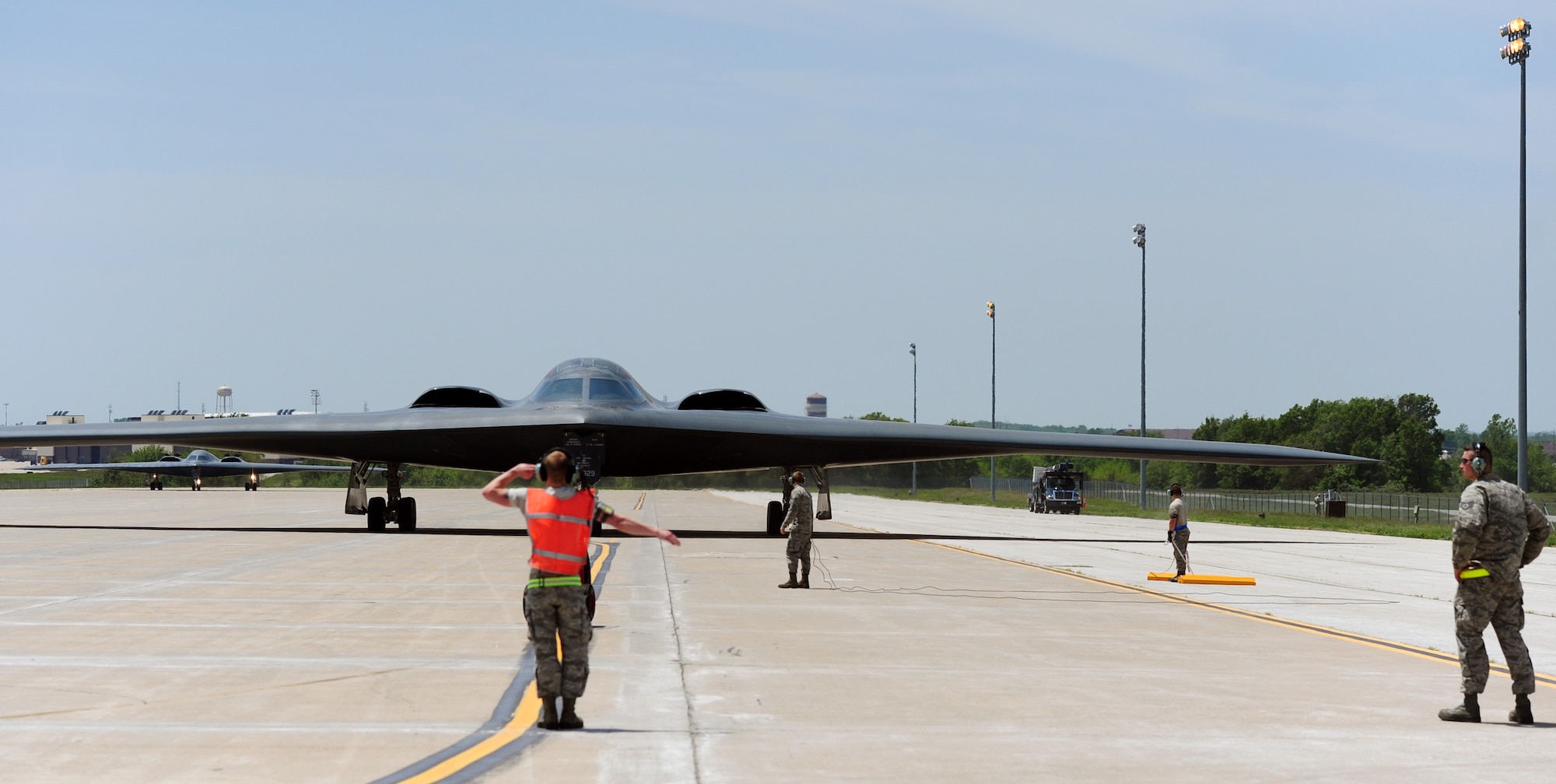 Crew chiefs from the 509th Aircraft Maintenance Squadron marshall a B-2 Spirit during exercise Constant Vigilance at Whiteman Air Force Base, Missouri, May 19, 2014. Bomb wings throughout Air Force Global Strike Command participated in Constant Vigilance to allow Airmen to demonstrate their ability to support nuclear deterrence and global strike operations across the globe. (U.S. Air Force photo by Staff Sgt. Nick Wilson/Released)