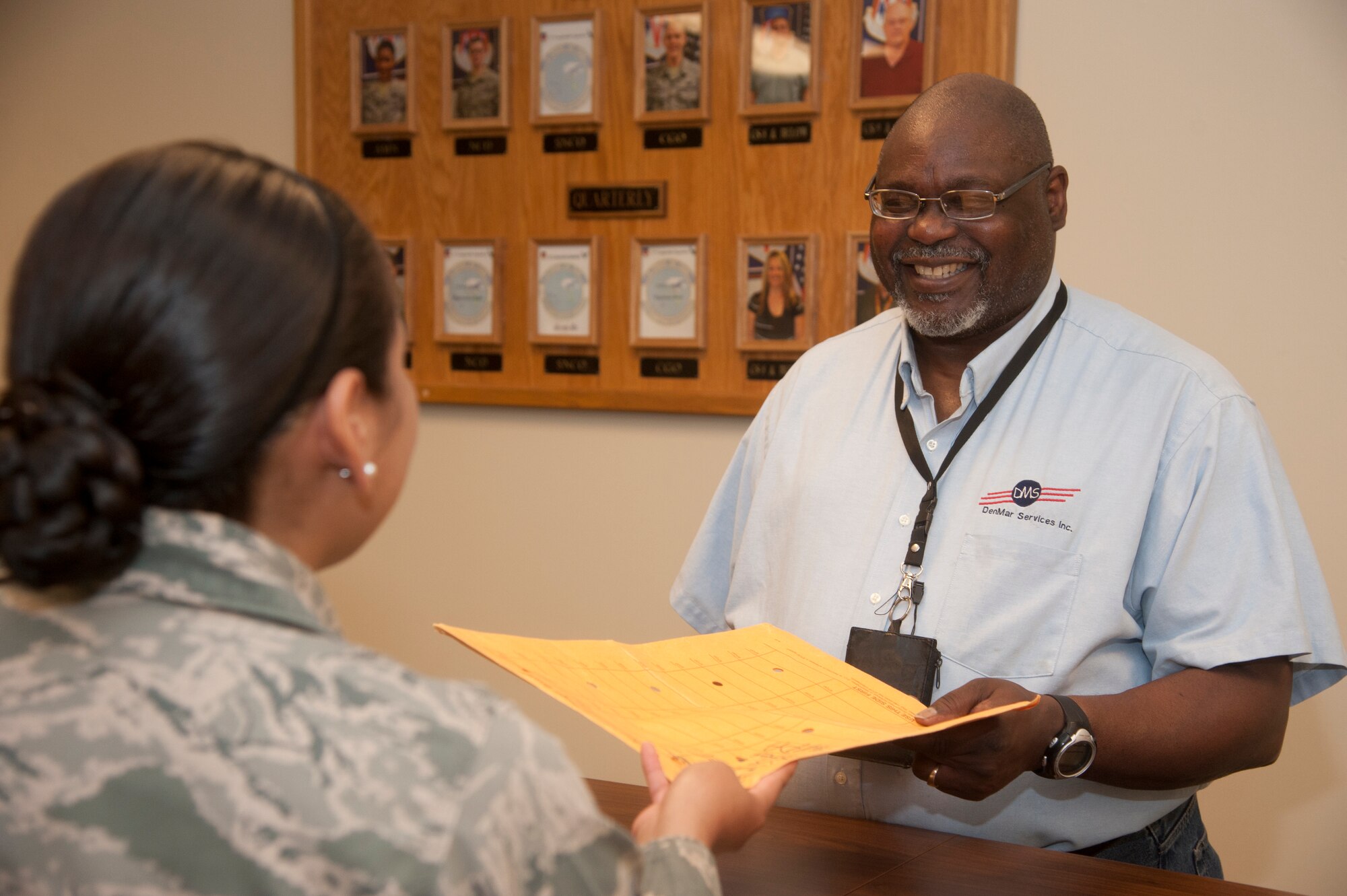 VANCE AIR FORCE BASE, Okla. -- Norris Williams, the postal administration and official mail center chief, delivers mail to an Airman May 15. Williams received the PAE Lightning Bolt award April 8. The Lightning Bolt Award recognizes PAE employees who demonstrate exceptional efforts and achievements that contribute to Vance’s mission and core values. (U.S. Air Force photo/Senior Airman Frank Casciotta)