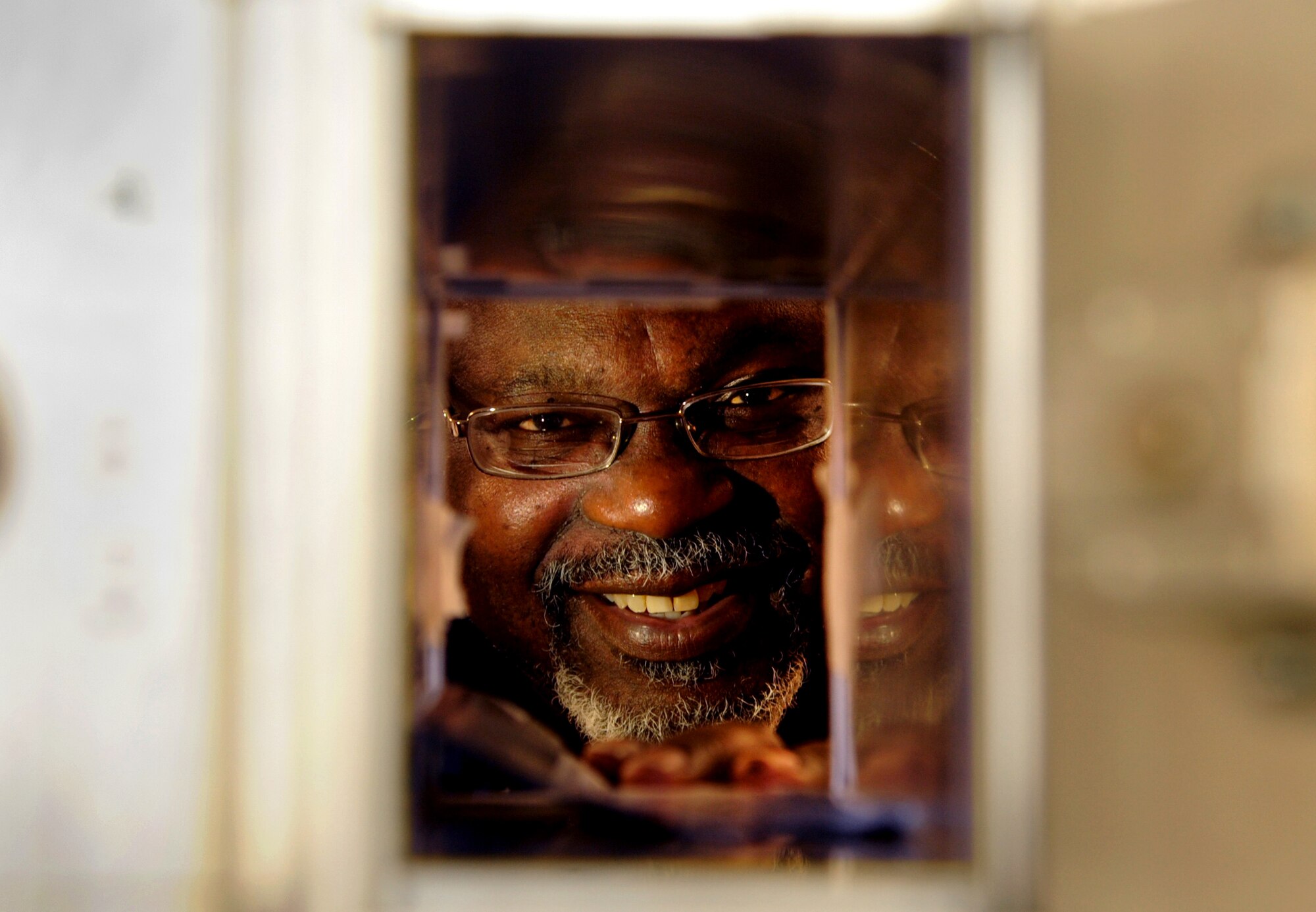 VANCE AIR FORCE BASE, Okla. -- Norris Williams, the postal administration and official mail center chief, places mail in a post office box at the Offical Mail Center May 20. Williams received the PAE Lightning Bolt award April 8. The Lightning Bolt Award recognizes PAE employees who demonstrate exceptional efforts and achievements that contribute to Vance’s mission and core values. (U.S. Air Force photo/Senior Airman Frank Casciotta)