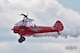 Carol Pilon strikes a pose on the wing of her 1940 Boeing-Stearman aircraft here, May 18, 2014. Pilon performed on the wings of the aircraft, piloted by Marcus Payne, as part of the 2014 Thunder Over the Valley Air Show and Open House, hosted here May 17-18. Pilon began wing-walking in 2001 and founded Third Strike Wingwalking in 2004 with the goal of inspiring young people to pursue aviation. Courtesy photo by Trevor Griffis/GSA Photography.