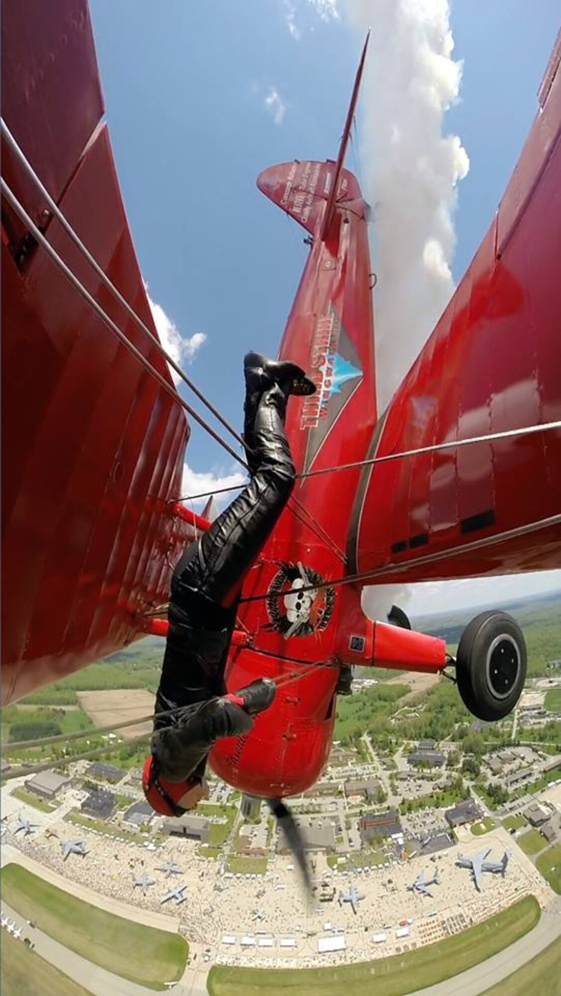 Carol Pilon flies on the wing of her 1940 Boeing-Stearman aircraft here, May 18, 2014. Pilon performed on the wings of the aircraft, piloted by Marcus Payne, as part of the 2014 Thunder Over the Valley Air Show and Open House, hosted here May 17-18. Pilon began wing-walking in 2001 and founded Third Strike Wingwalking in 2004 with the goal of inspiring young people to pursue aviation. Courtesy photo by Trevor Griffis/GSA Photography.