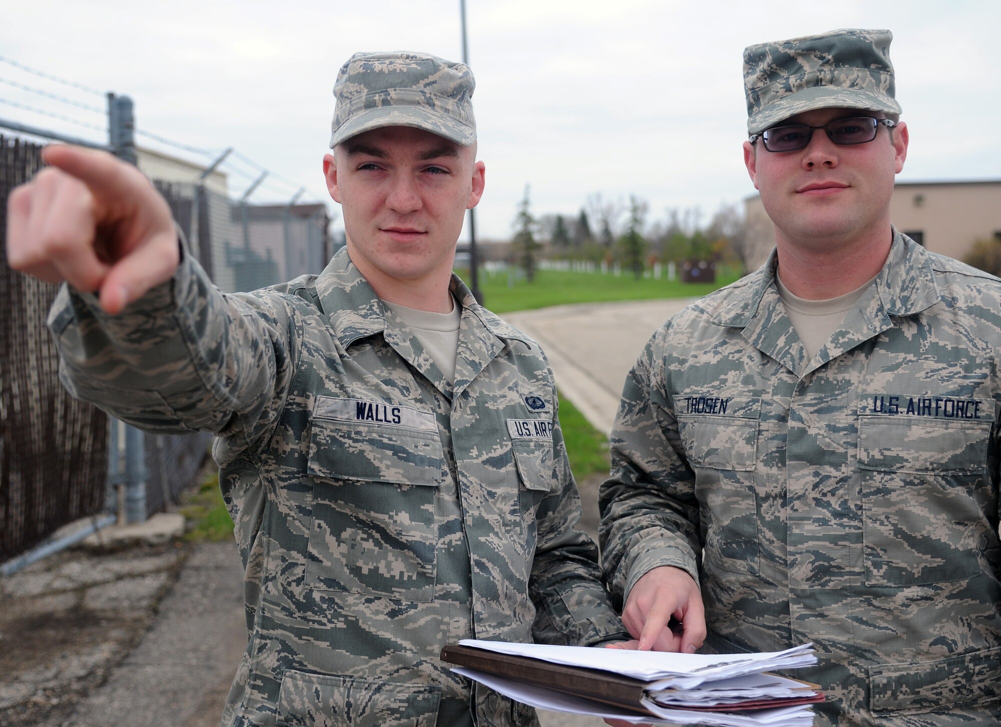 Airman 1st Class Richard Walls and Senior Airman Ernest Trosen, 319th Contracting Flight contract administrators, review specifications for an upcoming construction project on Grand Forks Air Force Base, N.D., May 21, 2014. Walls was named Warrior of the Week for the third week of May. (U.S. Air Force photo/Senior Airman Zachiah Roberson)
