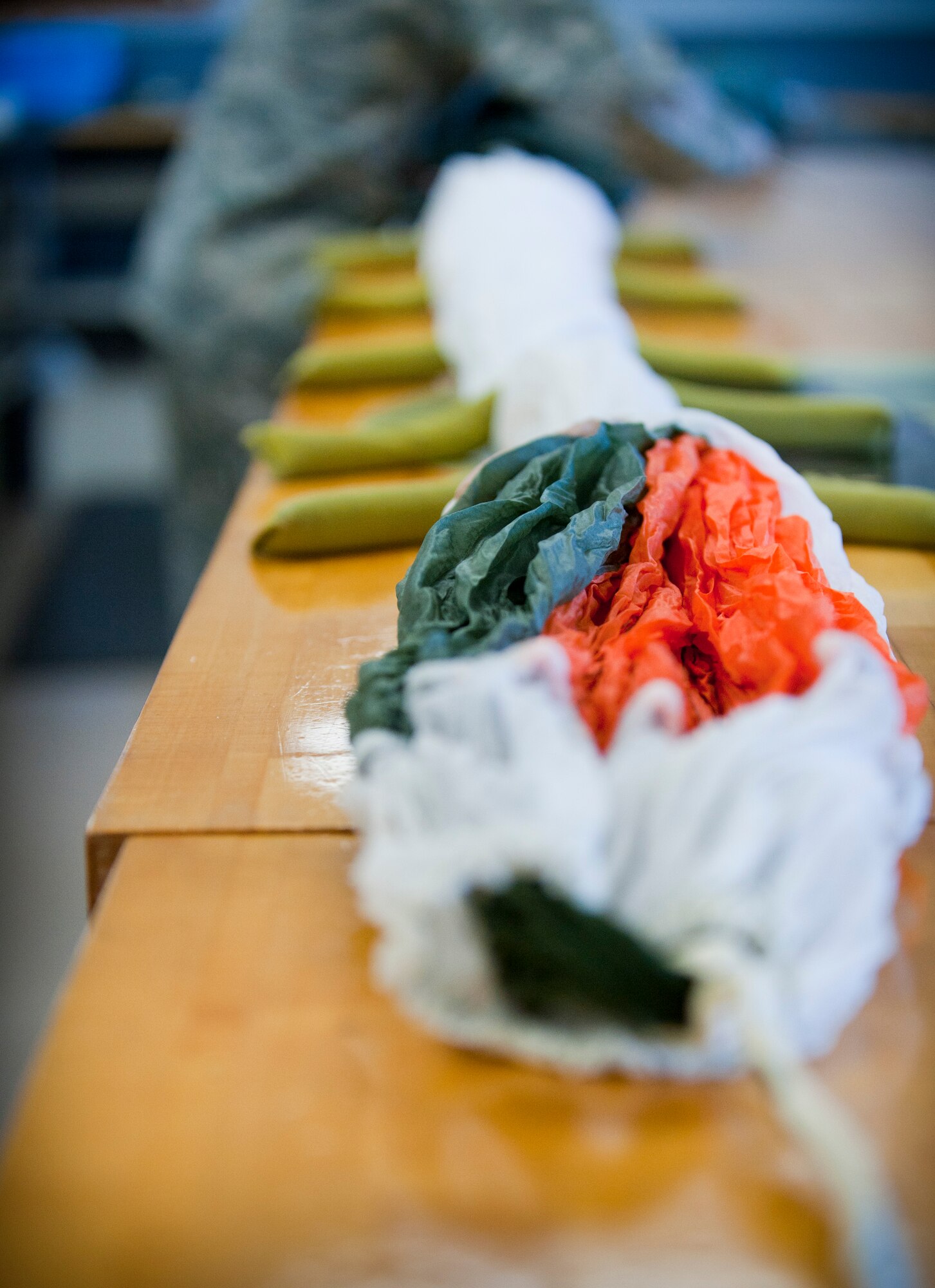 An Airman packs a back-automatic personnel paracute at the aircrew flight equipment shop on Hurlburt Field, Fla., May 20, 2014. The 1st Special Operations Support Squadron AFE shop inspects and packs about 60 back-automatic personnel parachutes a month. (U.S. Air Force photo/Senior Airman Krystal M. Garrett) 