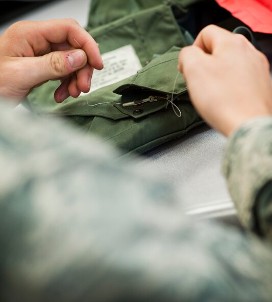 Airman 1st Class Tyler Holmes, 1st Special Operations Support Squadron aircrew flight equipment apprentice, inspects a life preserver unit at the AFE shop on Hurlburt Field, Fla., May 20, 2014. The 1st SOSS AFE shop inspects and packs about 100 LPUs a month. (U.S. Air Force photo/Senior Airman Krystal M. Garrett) 
