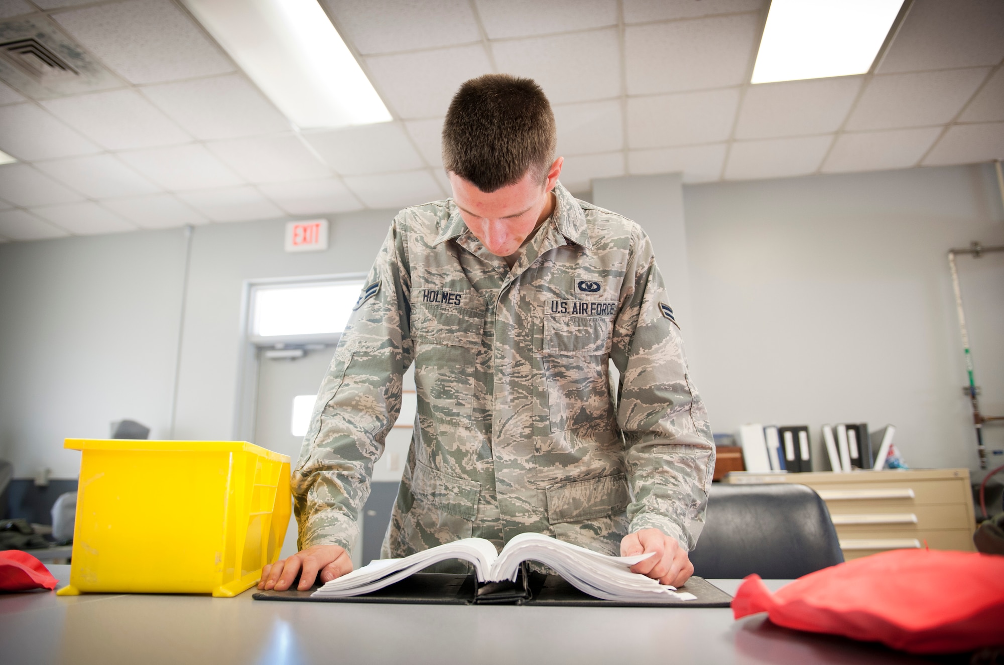 Airman 1st Class Tyler Holmes, 1st Special Operations Support Squadron aircrew flight equipment apprentice, reads an technical order before inspecting a life preserver unit at the AFE shop on Hurlburt Field, Fla., May 20, 2014. A technical order provides step-by-step instructions for repairing and maintaining equipment. (U.S. Air Force photo/Senior Airman Krystal M. Garrett) 