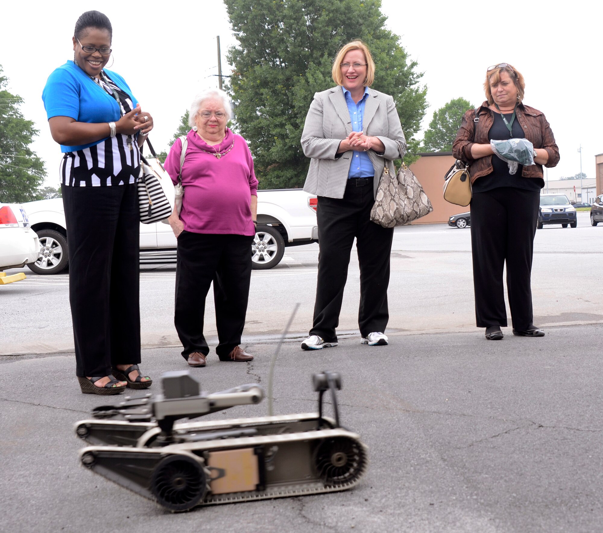 Saint Leo University Marietta Center staff members, Wanda Easton, assistant director of admissions, Diana Ehlers, staff assistant, Mary Estes, director and Dietlinde Dial, academic advisor, observe a bomb disposal robot operated by explosive ordnance disposal personnel from the 94th Civil Engineer Squadron, Explosive Ordnance Disposal Flight during a base tour on Dobbins Air Reserve Base, Ga. May 19, 2014. (U.S. Air Force photo/Don Peek)