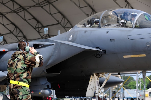 Senior Airman Jonathan Campbell, 4th Aircraft Maintenance Squadron crew chief, salutes outbound aircrew in an F-15E Strike Eagle aircraft during Employment Exercise CORONET WARRIOR 14-02, May 20, 2014, at Seymour Johnson Air Force Base, North Carolina. During the training exercise, maintenance personnel were tested on their ability to generate aircraft for takeoff during fluctuating force protection conditions. (U.S. Air Force photo/Senior Airman John Nieves Camacho)
