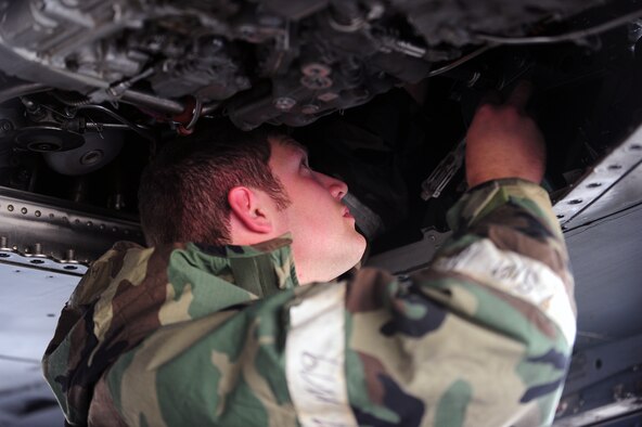 Senior Airman Spencer Wright, 4th Aircraft Maintenance Squadron aircraft electrical and environmental systems specialist, performs maintenance on an F-15E Strike Eagle aircraft during Employment Exercise CORONET WARRIOR 14-02, May 20, 2014, at Seymour Johnson Air Force Base, North Carolina. CORONET WARRIOR 14-02 assessed Airmen’s readiness and ability to complete missions in a deployed environment. (U.S. Air Force photo/Senior Airman John Nieves Camacho)