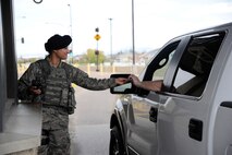 Staff Sgt. Rachel Spahr, 341st Security Forces Squadron member, checks a driver’s identification card at the main gate of Malmstrom Air Force Base on May 17.  Security forces members have 12-hour shifts guarding the main gate to provide adequate security for Malmstrom 24/7. (U.S. Air Force photo/Airman 1st Class Collin Schmidt)