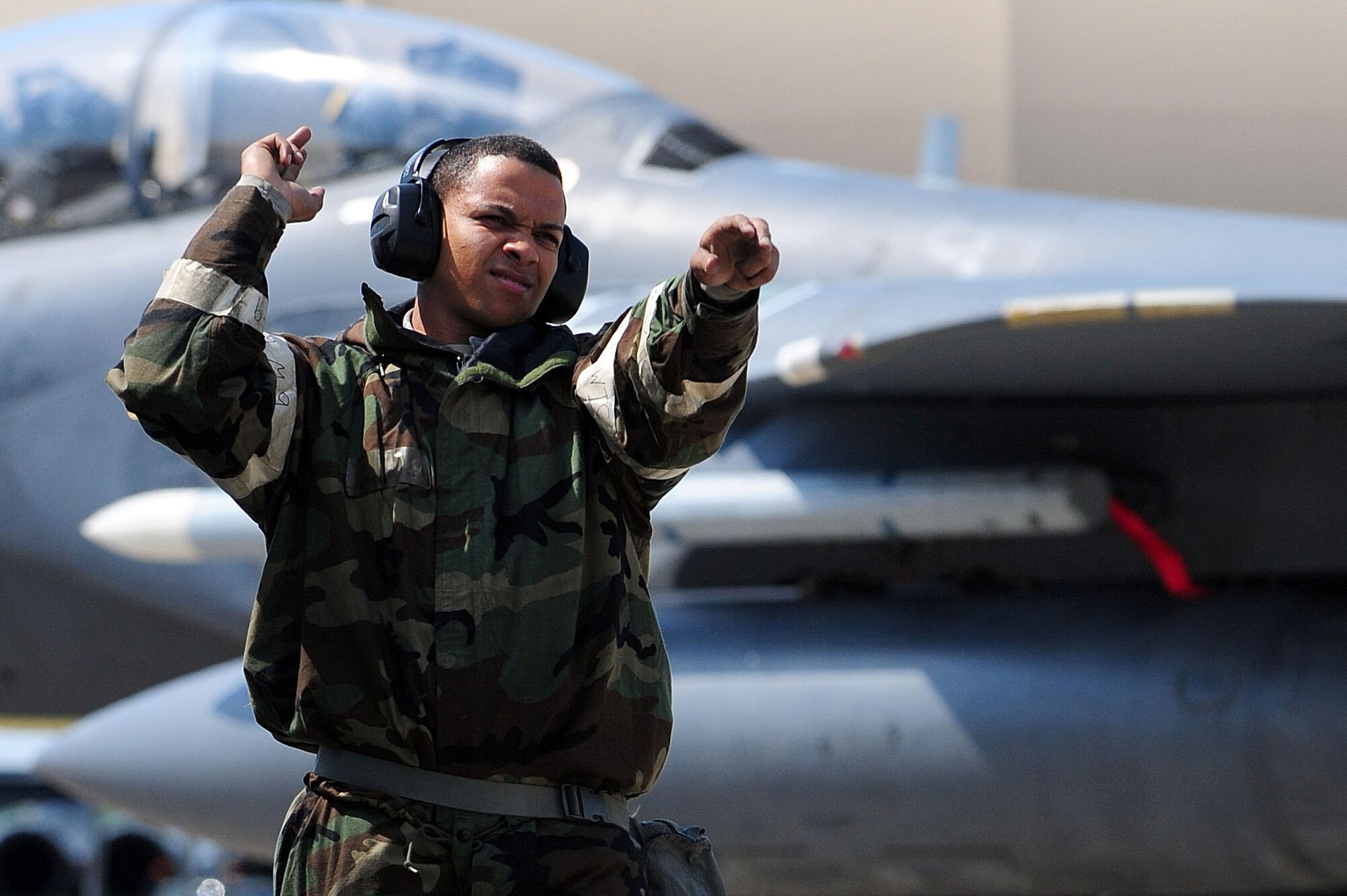 Airman 1st Class Jose Ramirez, 4th Aircraft Maintenance Squadron crew chief, marshals an F-15E Strike Eagle aircraft during Employment Exercise CORONET WARRIOR 14-02, May 20, 2014, at Seymour Johnson Air Force Base, North Carolina. The exercise honed the skills of 4th Fighter Wing Airmen on emergency response and recovery procedures. (U.S. Air Force photo/Senior Airman John Nieves Camacho)