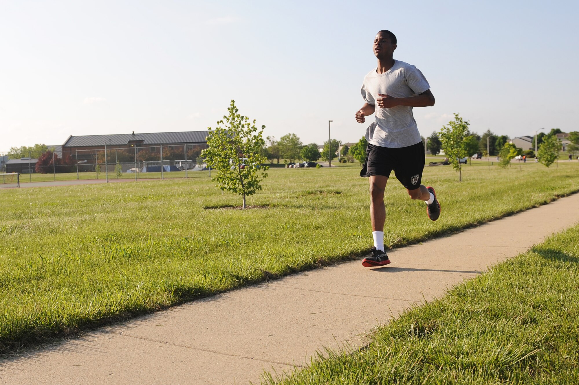 Senior Airman Marcus Marshall finishes first during the 1st Annual Team Scott Port Dawg Memorial 5K at Scott Air Force Base, Ill., May 12, 2014.  To celebrate National Defense Transportation Week, Team Scott was invited to come to the run/walk and remember 16 fallen port dogs.    Marshall is a 375th Logistics Readiness Squadron small air terminal representative.  (U.S. Air Force photo by Staff Sgt. Maria Bowman)
