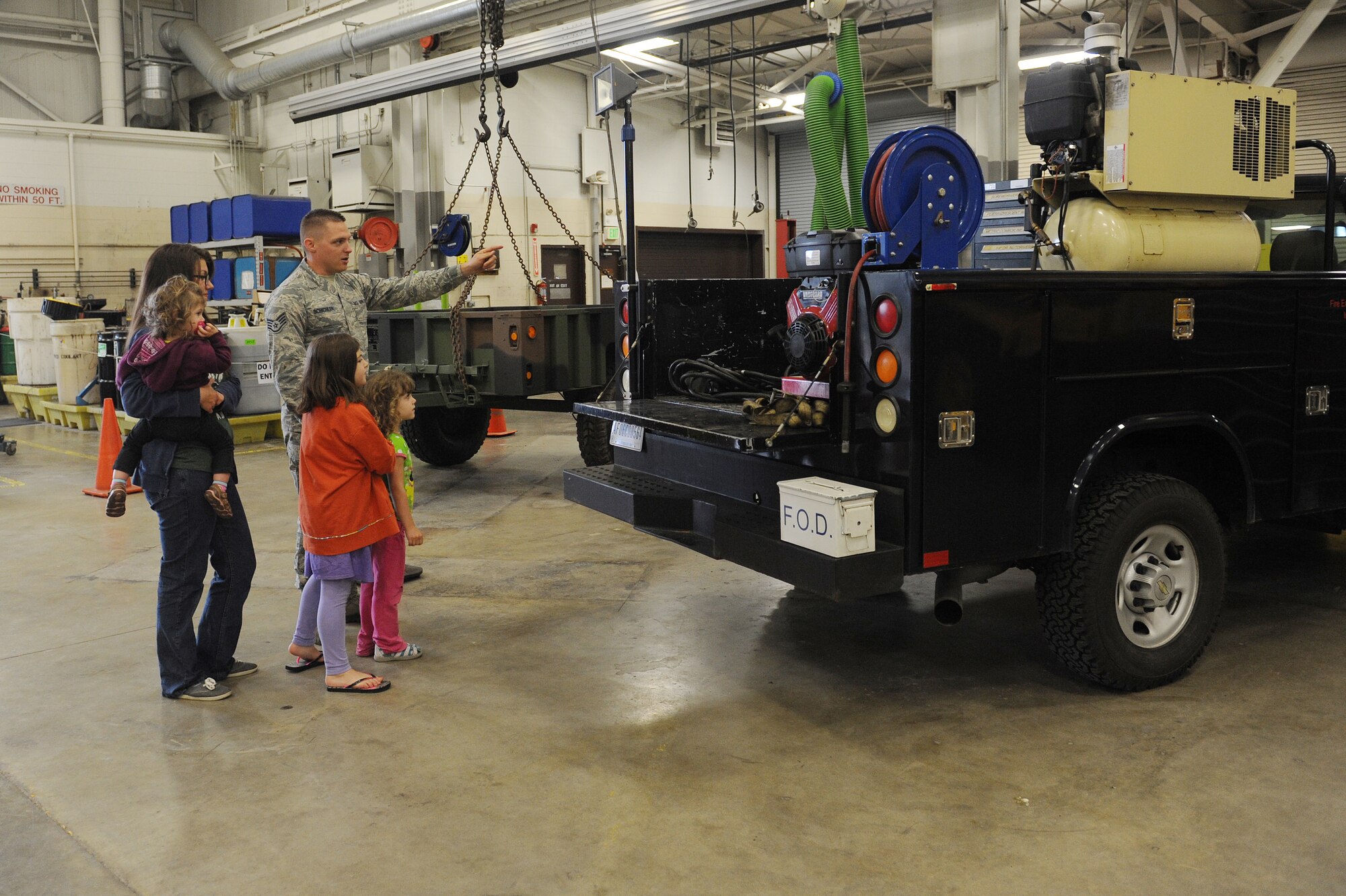 Staff Sgt. Justin Schichler shows his family the Vehicle Maintenance Mobile truck during the transportation demonstration exhibit at Scott Air Force Base, Ill., May 14, 2014.  This vehicle is a quick response asset for minor breakdowns of government-owned assets.  To commemorate National Transportation Week, the base is hosting a number of events from May 12-16, including transportation demonstrations of the vehicles from the static display and a 5K walk/run to honor fallen transportation personnel.   Schichler is a 375th Logistics Readiness Squadron vehicle maintenance craftsman.  (U.S. Air Force photo by Staff Sgt. Maria Bowman)