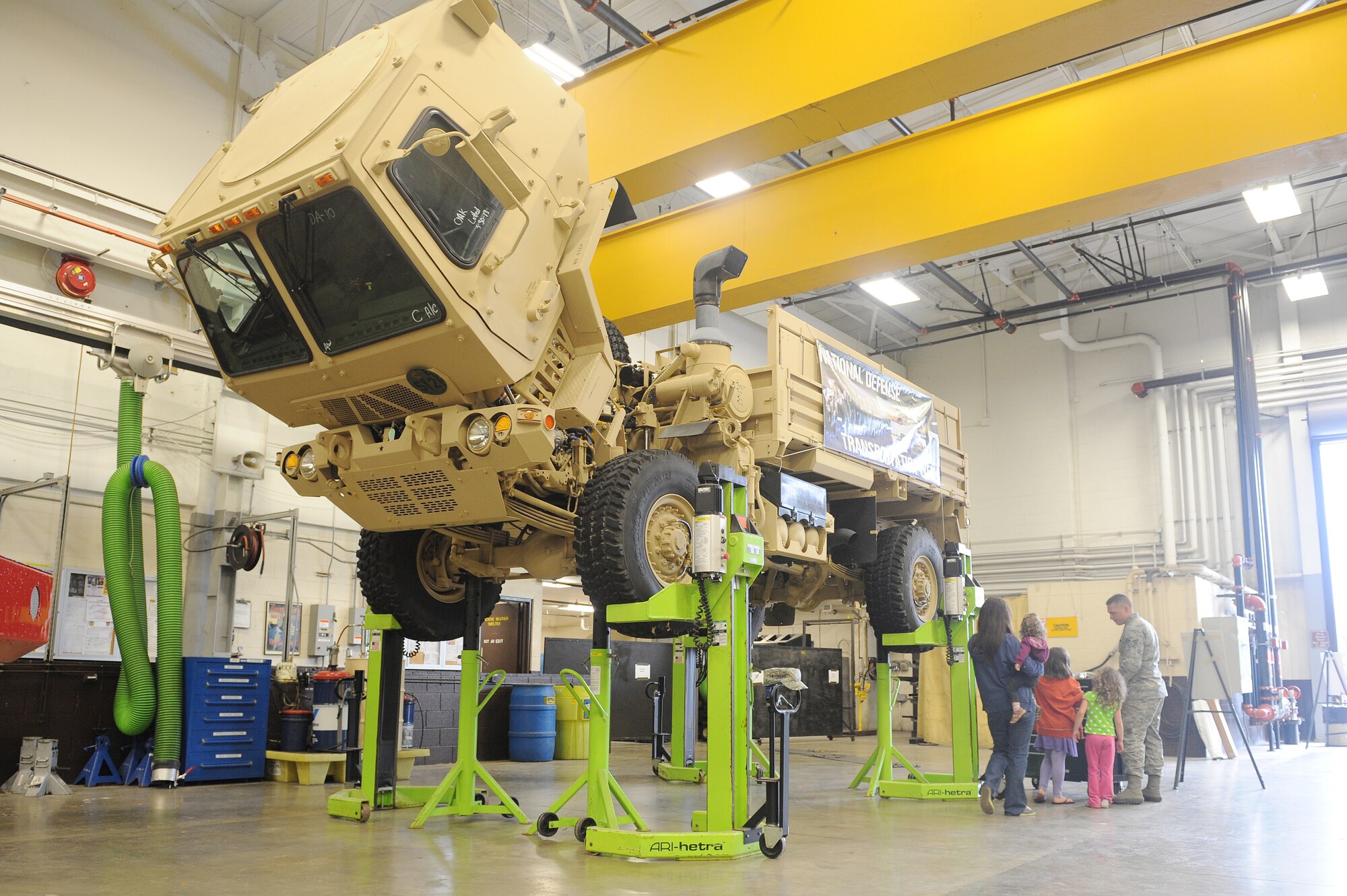 Staff Sgt. Justin Schichler shows his family the Light Medium Tactical Vehicle cargo truck at the transportation demonstration exhibit at Scott Air Force Base, Ill., May 14, 2014.  This truck can perform local and line haul, unit mobility, unit resupply and other missions in combat, combat support and combat service support units.  It is rapidly deployable worldwide and operates on primary and secondary roads and conditions.  Schichler is a 375th Logistics Readiness Squadron vehicle maintenance craftsman.  (U.S. Air Force photo by Staff Sgt. Maria Bowman)