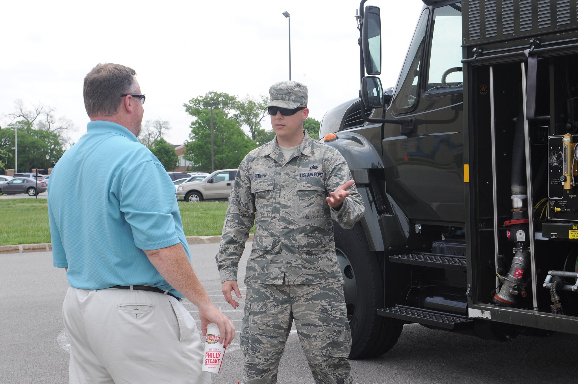 Staff Sgt. Richard Gerber briefs on an R-11 Refueler during a static display at Scott Air Force Base, Ill., May 12, 2014.  This vehicle is a 6,000 gallon mobile refueling unit that can refuel any aircraft and can issue up to 600 gallons a minute.  At Scott AFB, it services C-21s, C-130s and C-40s.  Gerber is the 375th Logistics Readiness Squadron fuels information manager.  (U.S. Air Force photo by Staff Sgt. Maria Bowman)