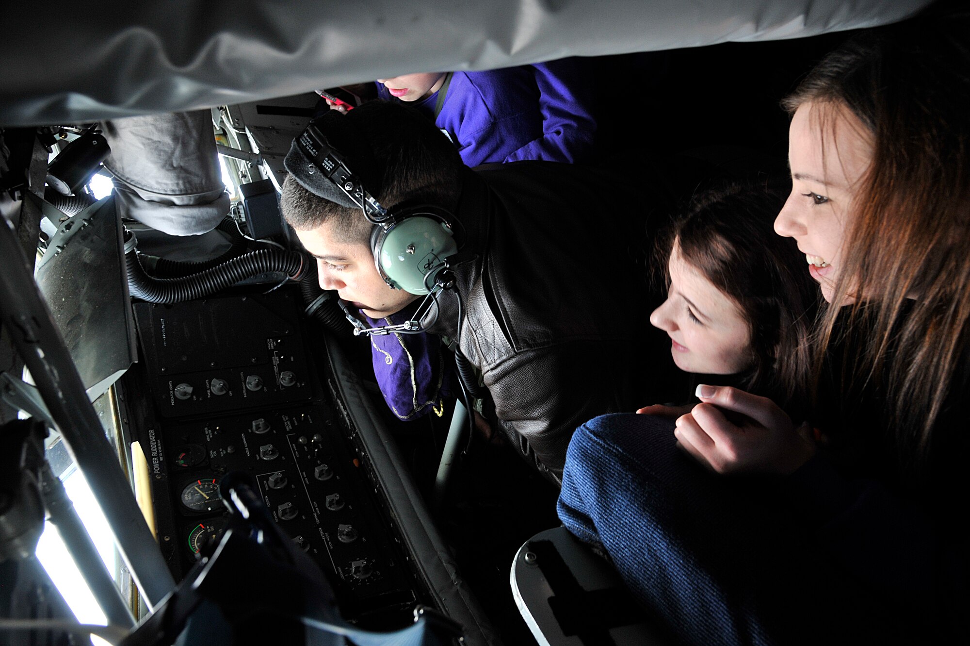 Rebekah Fields and Chelsea Evans look on as Senior Airman Anthonie Owens refuels an F-15 Eagle from Kingsley Field Air National Guard Base, Ore., during a training mission over the coast of Oregon, May 20, 2014. Fields and Evans, along with other members of the 2014 Spokane Lilac Princess Royal Court, were able to experience the air refueling mission firsthand as members of the incentive flight and received a tour of Fairchild Air Force Base, Wash. Owens is a 93rd Air Refueling Squadron boom operator. (U.S. Air Force photo by Senior Airman Mary O'Dell/Released)